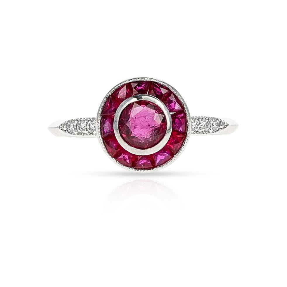 A French Ruby and Diamond Platinum Ring. The center ruby is 0.78 carats. The total weight of the ring is 4.64 grams. The ring size is US 6.25. 

