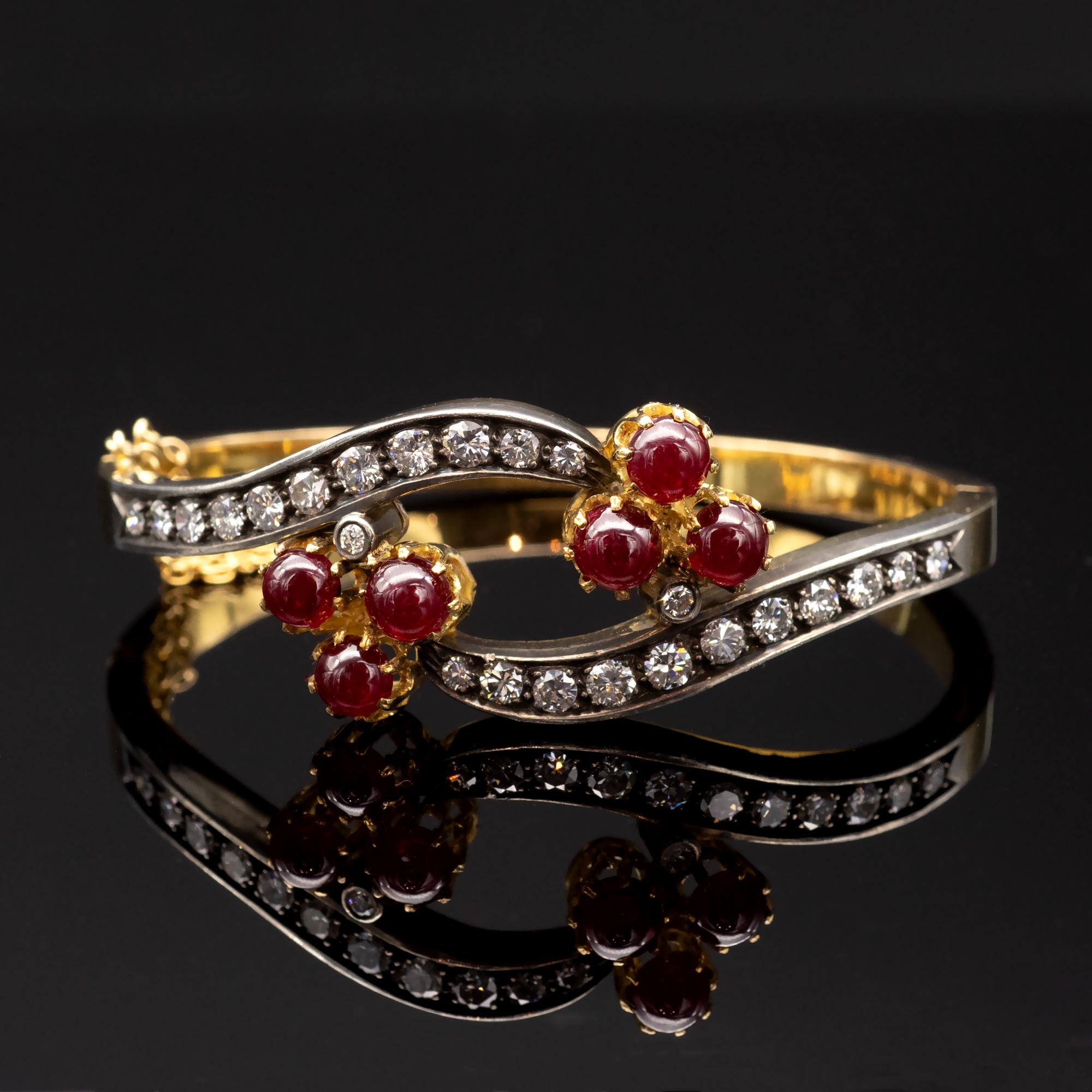 Indulge in luxurious elegance with this exquisite antique bracelet, crafted from 18-Kt Gold and embellished with 24 top-quality white diamonds and 6 gorgeous cabochon rubies totaling approximately 8 carats. 
The diamonds are set atop a thin layer of
