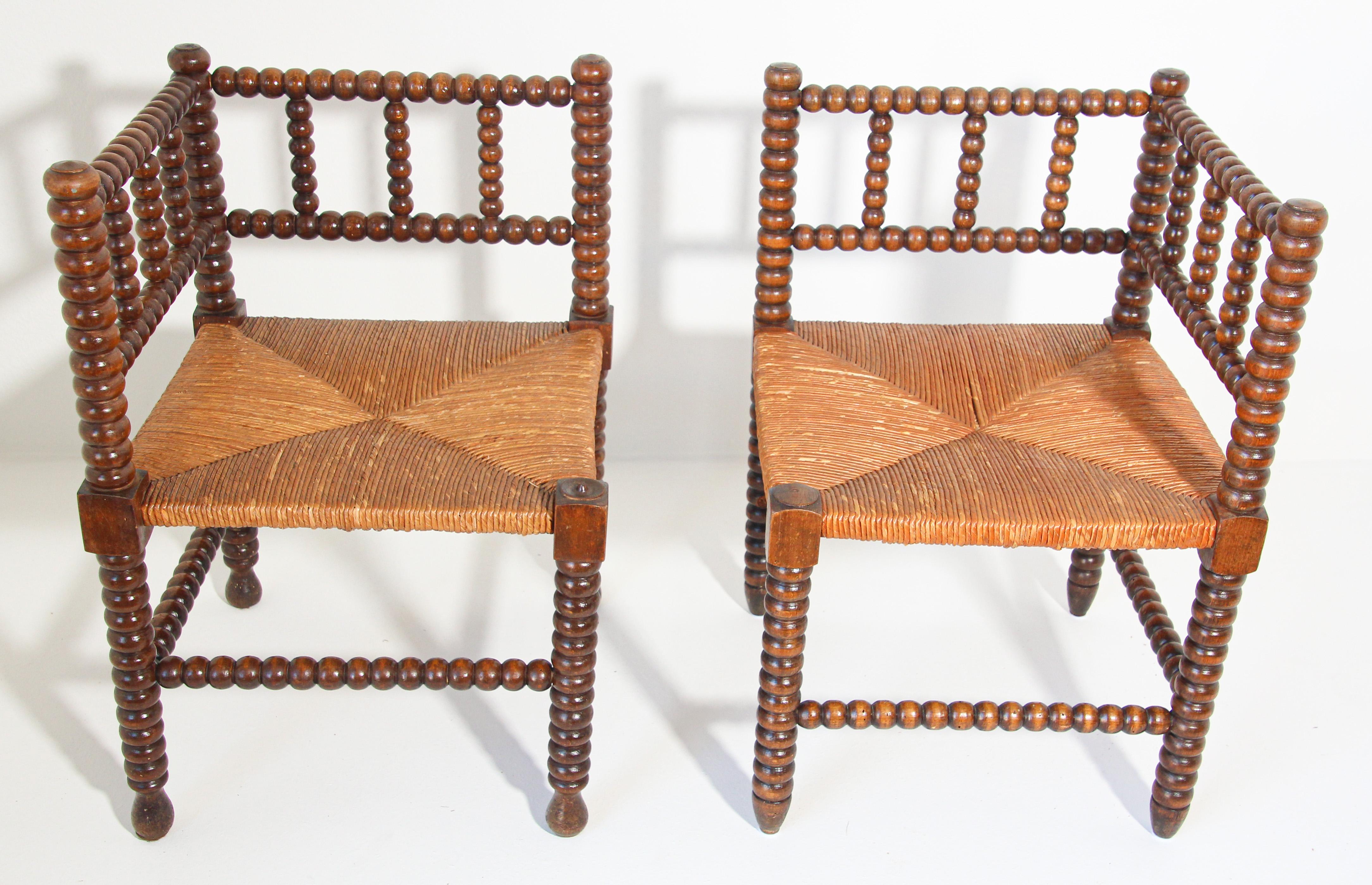 Pair of French rush-seat corner chairs, Coin du Feu.
Pair of French Provincial-style carved fruitwood armchairs with open backs and rush seats. 
Pair of antique sturdy useable chair, wood stick and ball craftsmanship corner chair with original rush