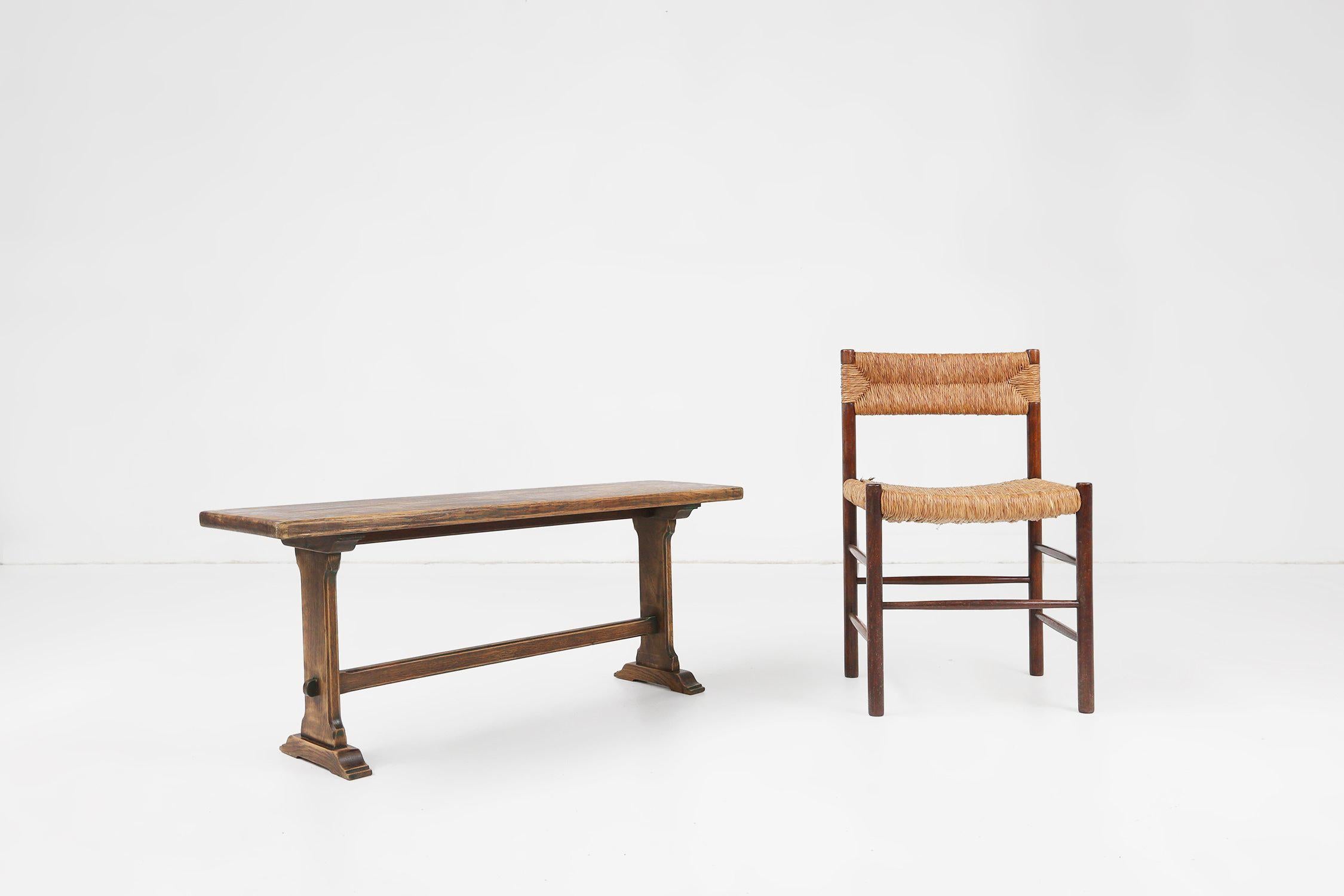 France / 1900 / bench / wood / rustic / mid-century / france  

Rustic wooden bench in solid wood, made in France around 1900. The bench features a thick solid top supported by a 2 legged base. The gracefully curved legs are conjoined by a long hand