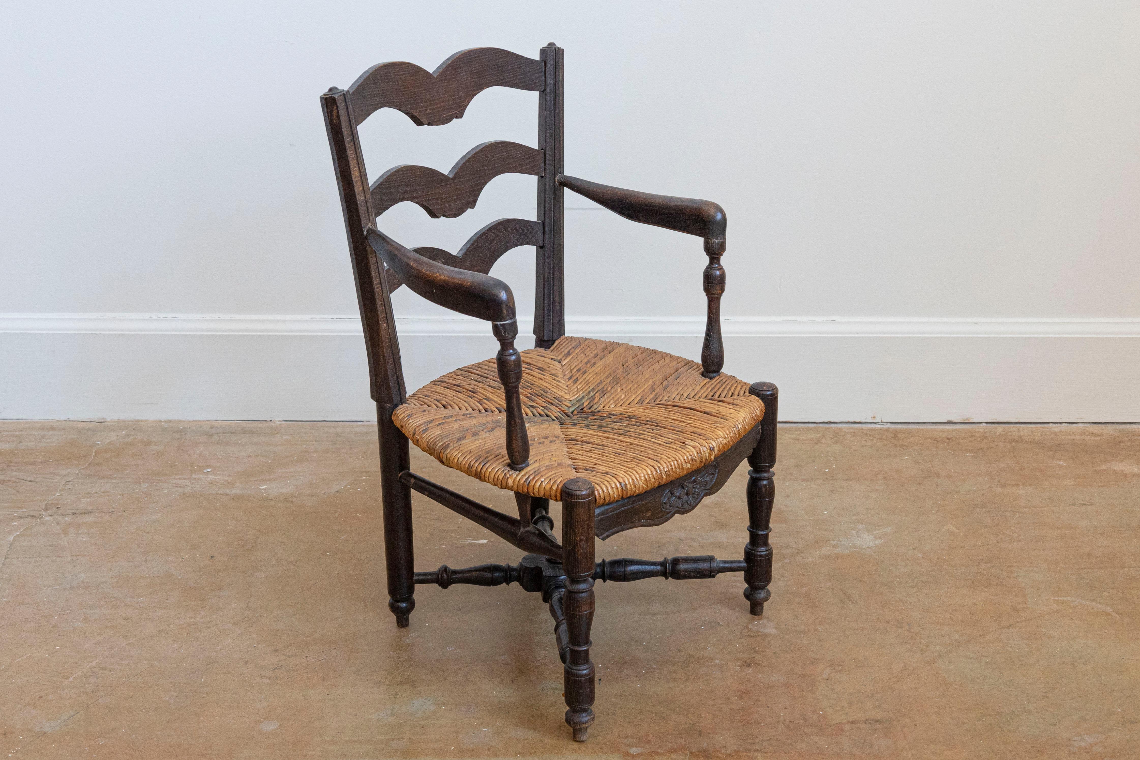 Carved French Rustic Dark Oak 19th Century Child's Chair with Ladder Back and Rush Seat For Sale