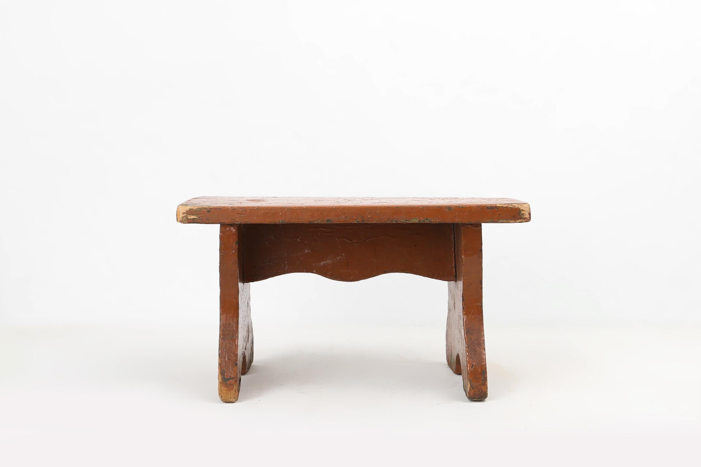 Rustic French rustic low church stool in terracotta painted wood, ca. 1900 For Sale