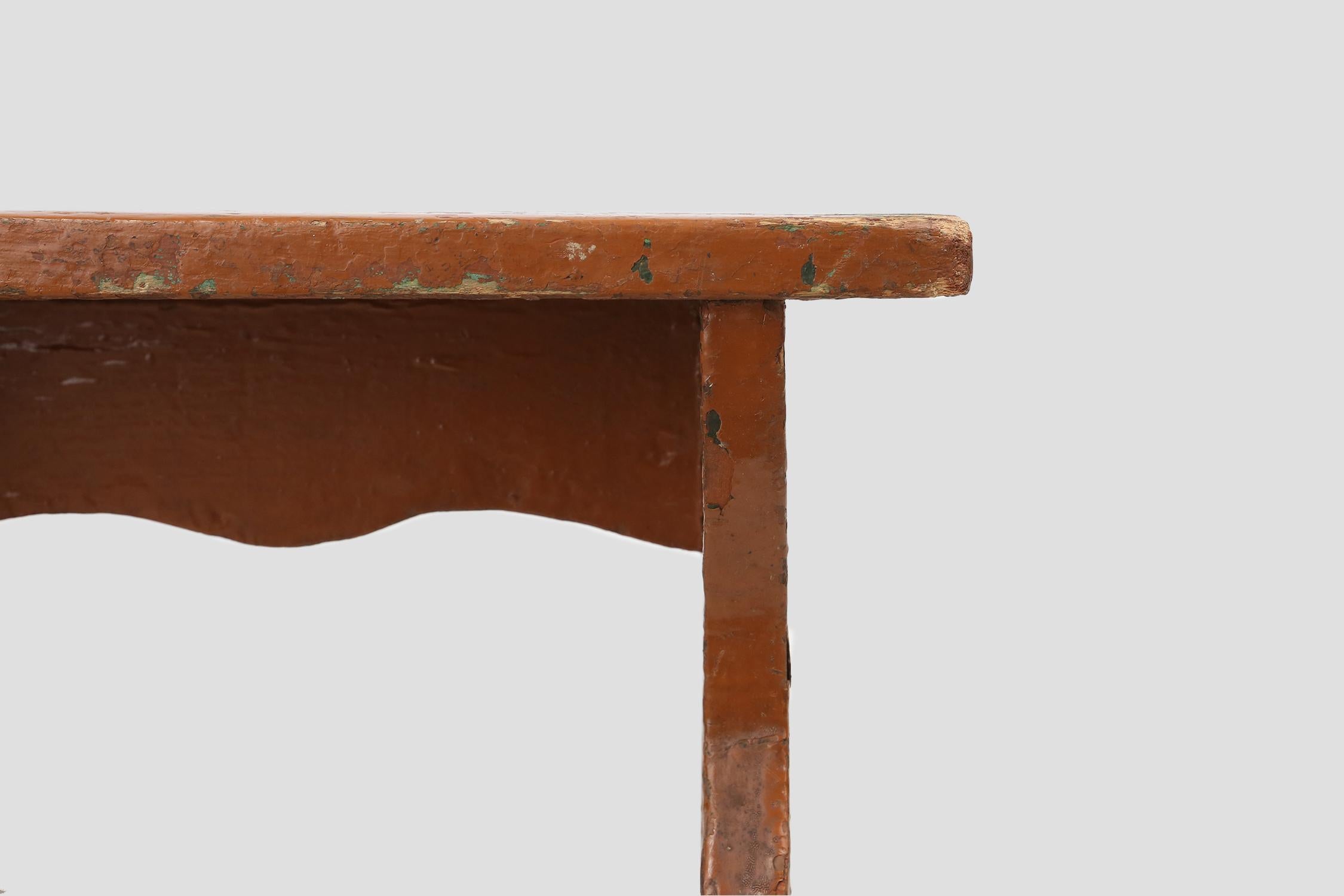 Painted French rustic low church stool in terracotta painted wood, ca. 1900 For Sale