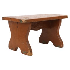 French rustic low church stool in terracotta painted wood, ca. 1900