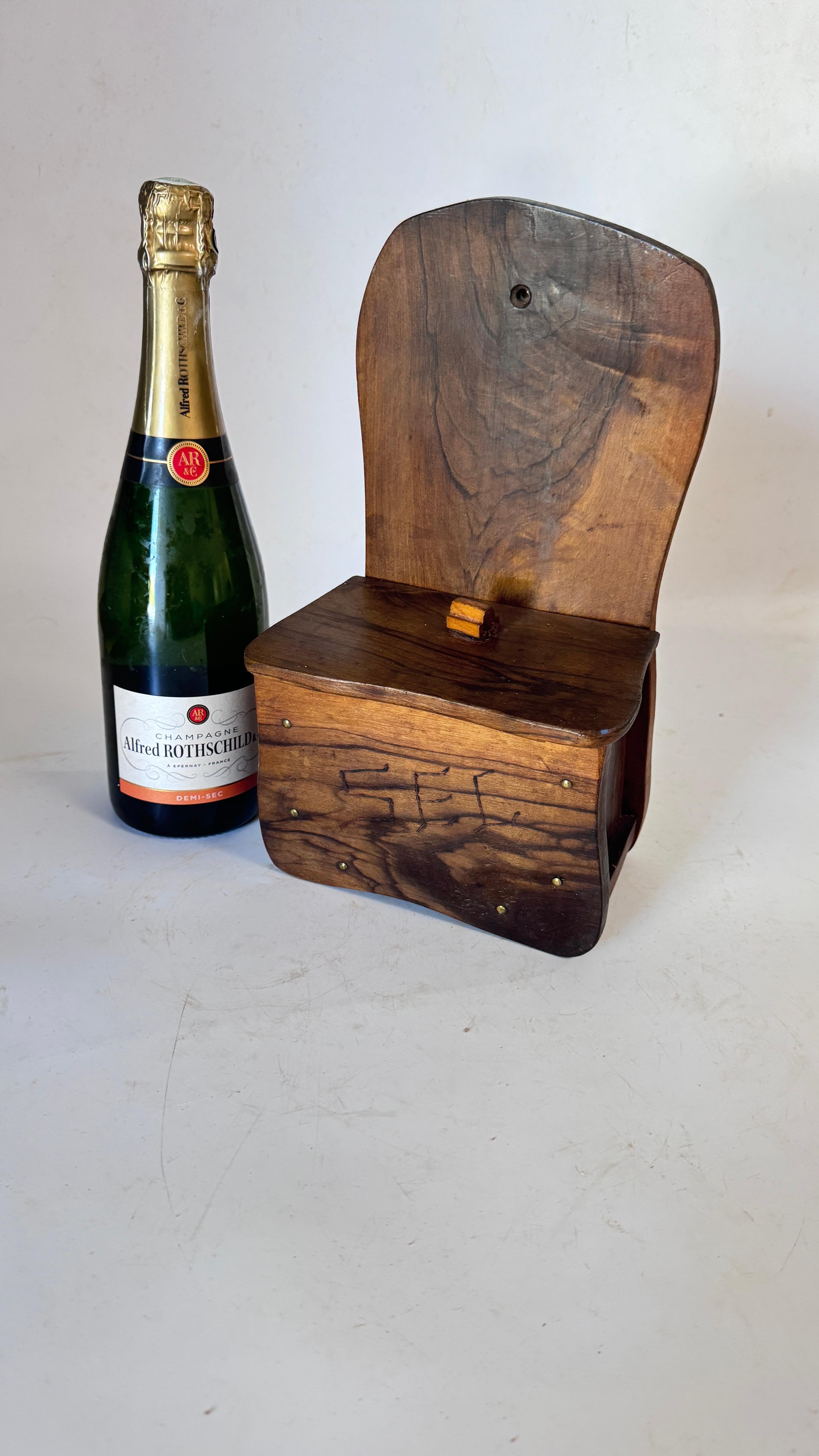 French Rustic Olive Wood Salt Box – Wall-Mounted – 1970s Artisan Craft

Description:
This is a beautiful rustic salt box, handcrafted in solid olive wood, made in France in the 1970s. Entirely artisan-made, it showcases the natural grain and warm