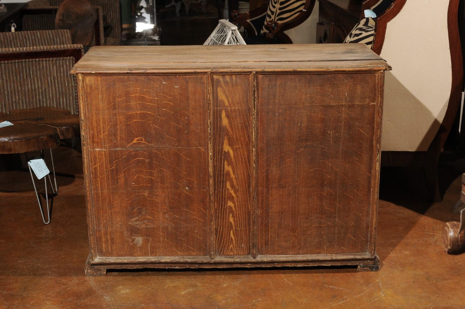 A French rustic tall shopkeeper's chest from the 19th century, with 10 drawers. Born in France during the 19th century, this handsome shopkeeper's chest features a rectangular planked top with nicely weathered appearance, sitting above a