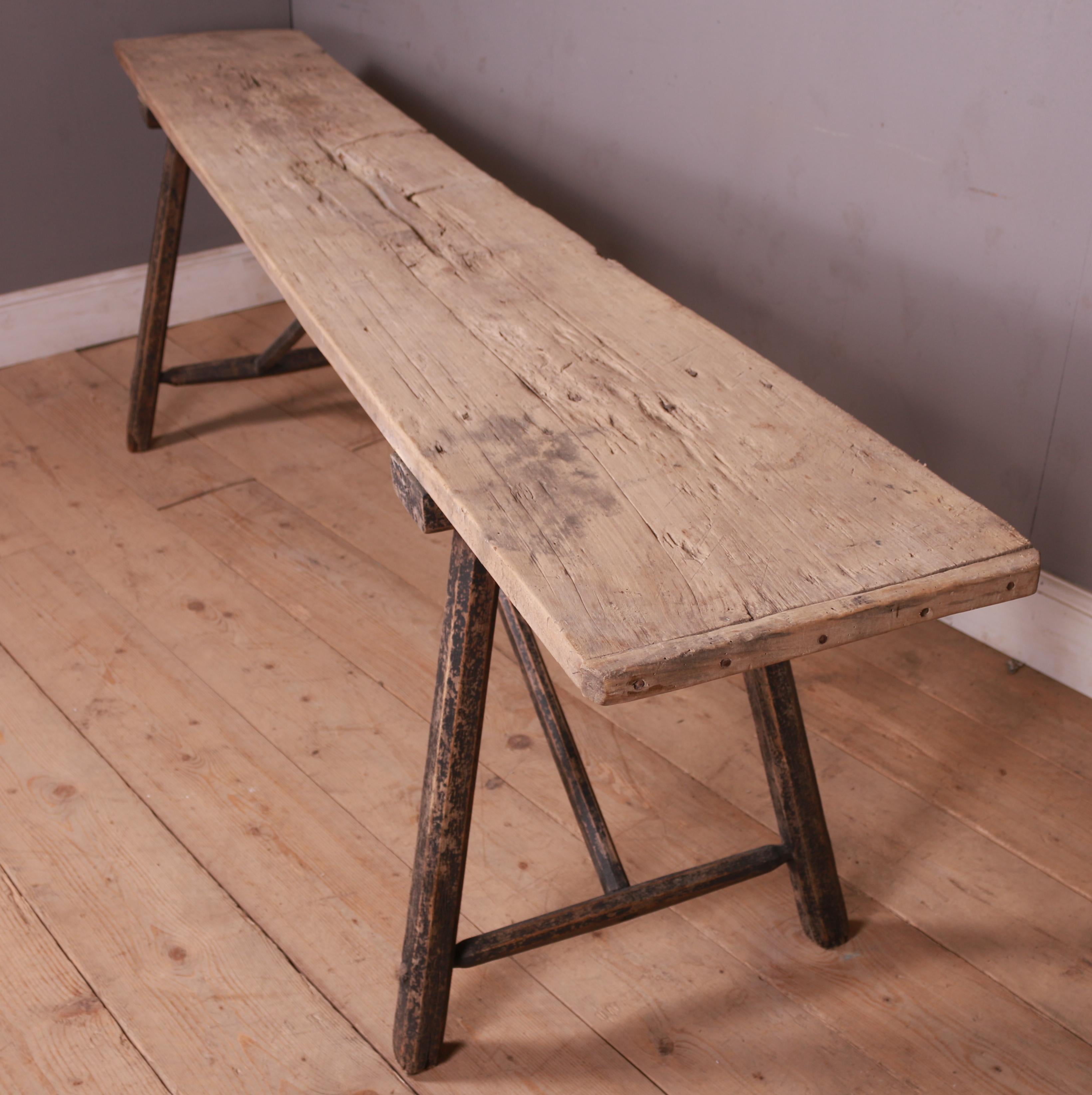 Long 19th C French rustic trestle table with worn old black paint. 1880.

Top is 16