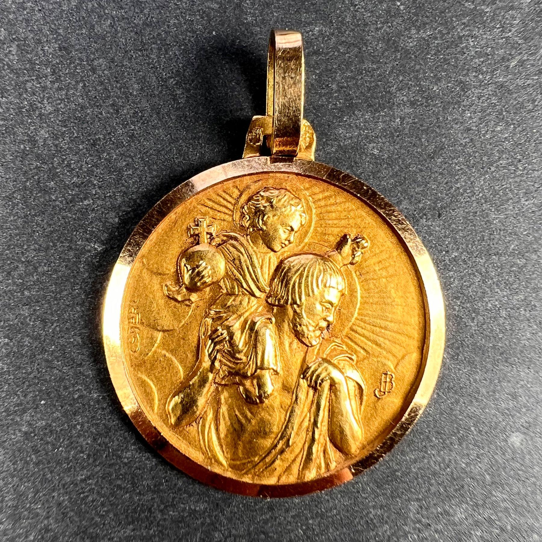 A French 18 karat (18K) yellow gold charm pendant designed as a medal depicting Saint Christopher carrying the infant Christ. Signed C. Charl and initialled JB. Stamped with the eagle mark for 18 karat gold and French manufacture with an unknown