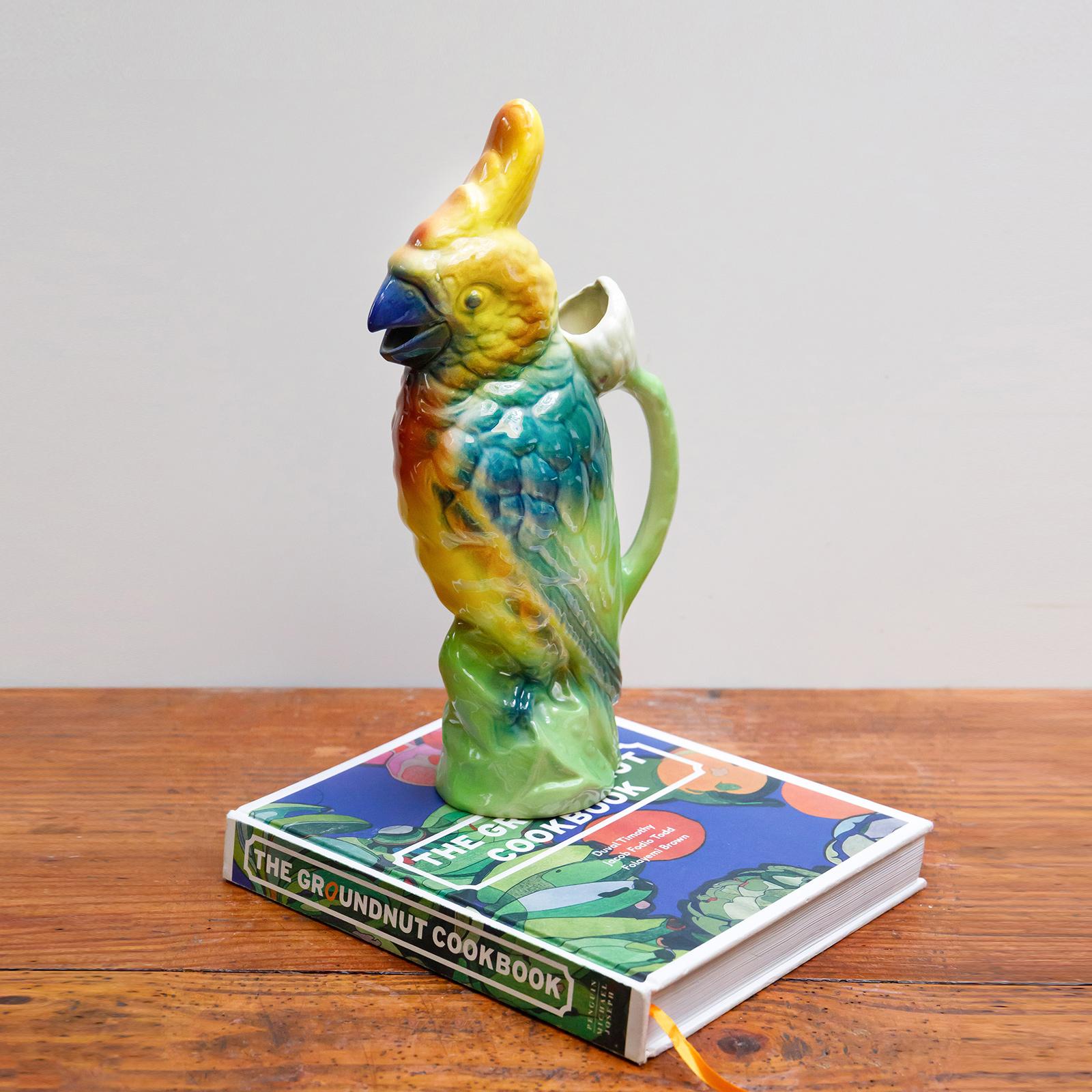 French majolica parrot absinthe or water pitcher by St. Clément.

In good condition, the pitcher showcases a vibrant coloration and glaze, making it an excellent decorative piece for any table setting.

St. Clément Pottery boasts a rich history