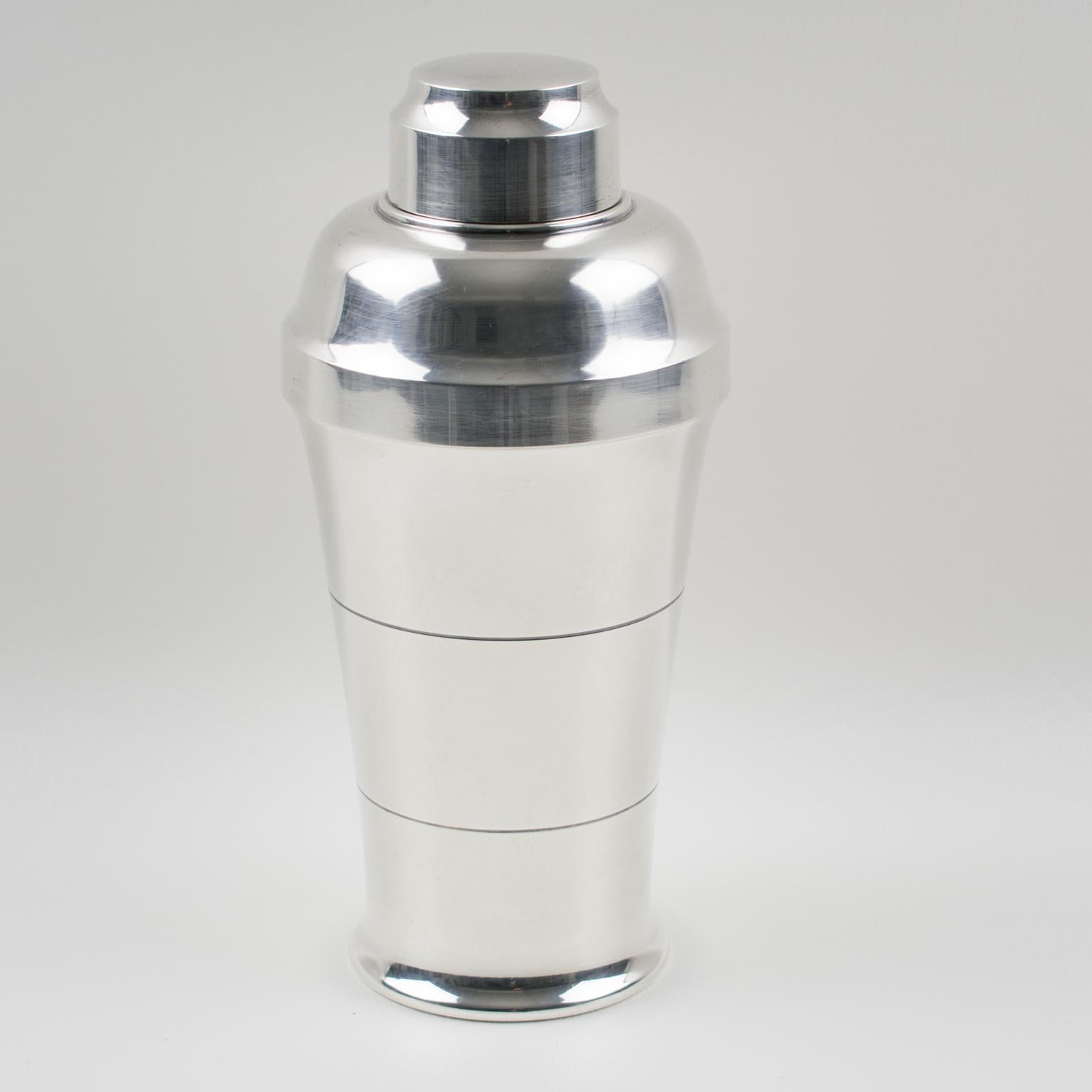 Elegant French Art Deco silver plate cylindrical cocktail or Martini Shaker by silversmith Saint Medard, Paris. Three sectioned designed cocktail Shaker with removable cap and strainer. Lovely Art Deco design with geometric design. Marked underside: