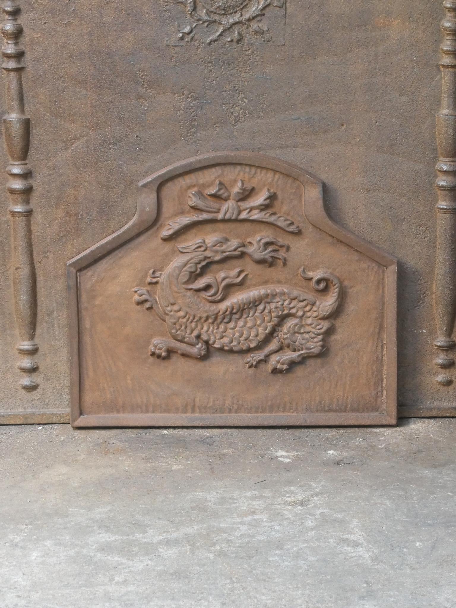 French 20th century Modernist fireplace fireback with a salamander. The salamander is symbol of François I (king of France) who reigned from 1515-1547, during the French Renaissance period.

The fireback is made of cast iron and has a natural brown