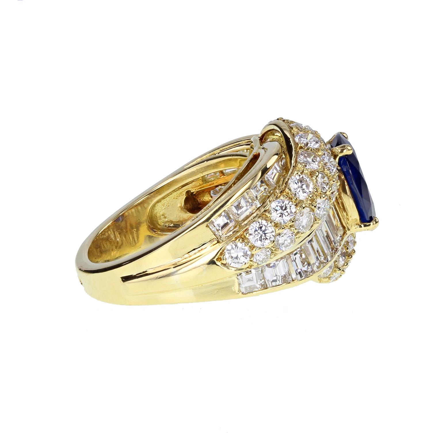 This 1940s cocktail ring features a central oval brilliant-cut blue sapphire, mounted in four claws, surrounded by an elaborate crossover setting pave-set with brilliant cut diamonds and channel-set with baguette-cut diamonds. French assay marks to