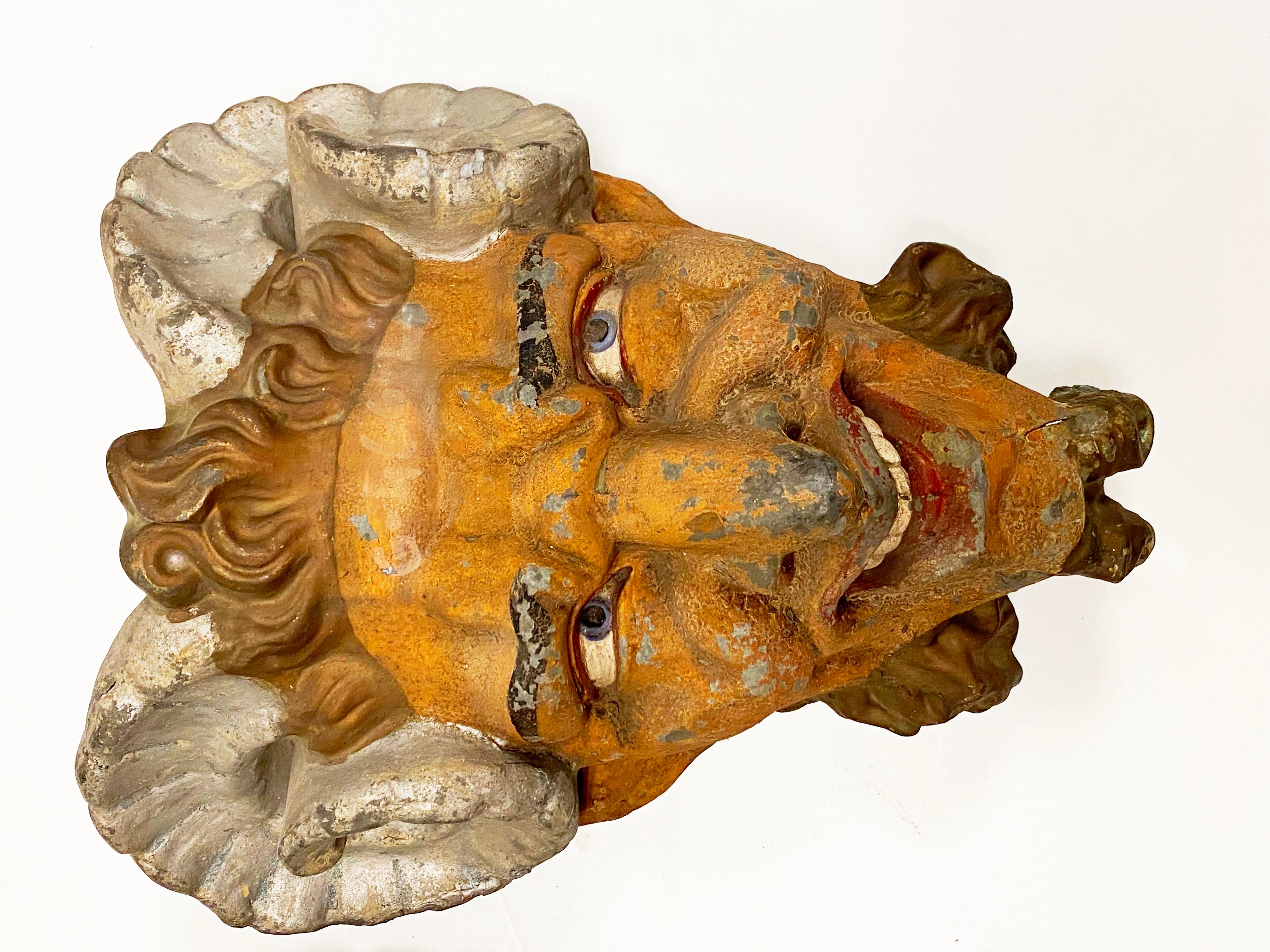 French belle epoque period pair of faun or satyr head wall ornaments in painted zinc, likely from an amusement park.