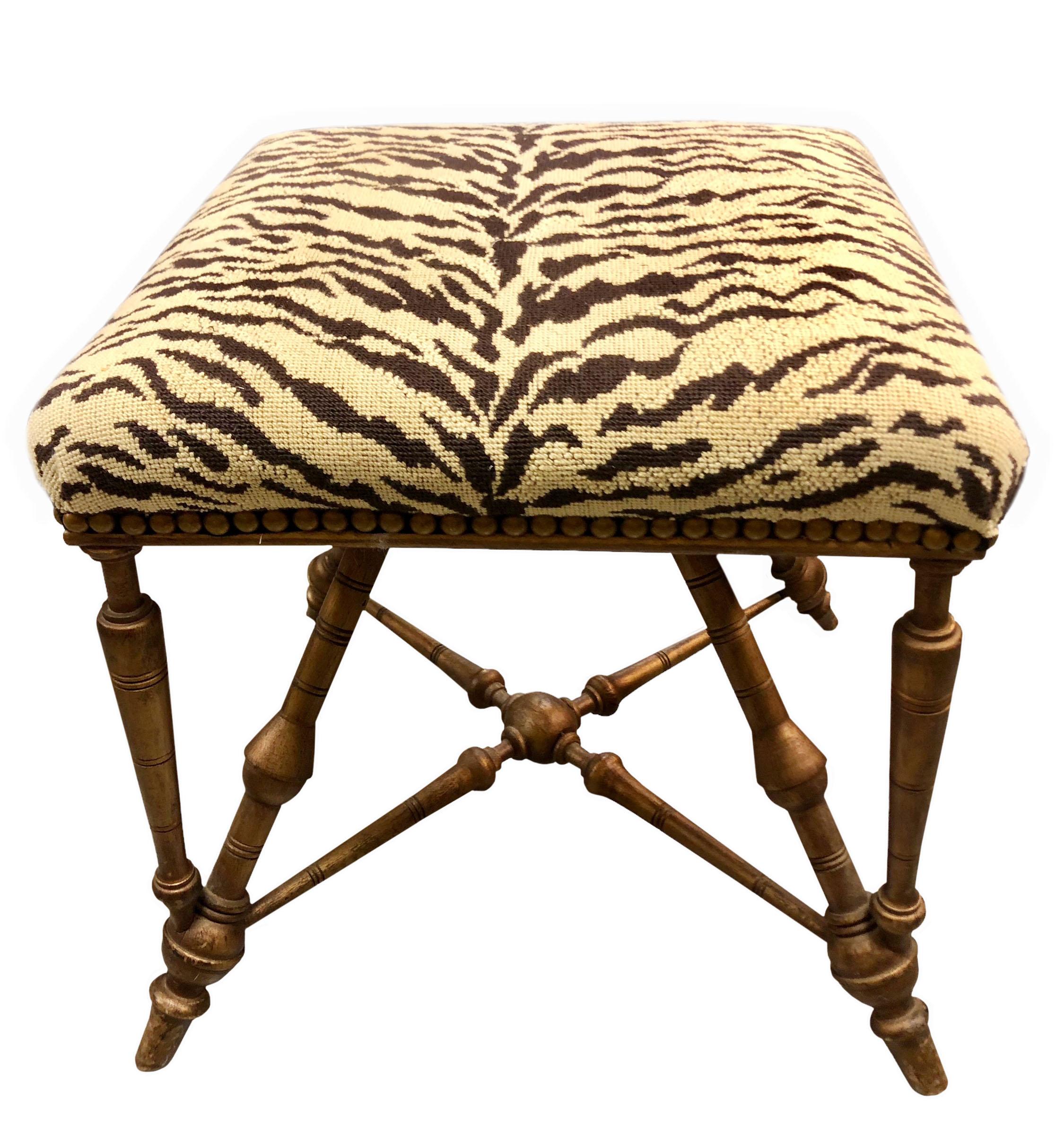 French late 19th century gold bamboo stool reupholstered with vintage,1980s gold and black cotton Scalamandré tiger fabric that appears embroidered. Antique colored nail heads.