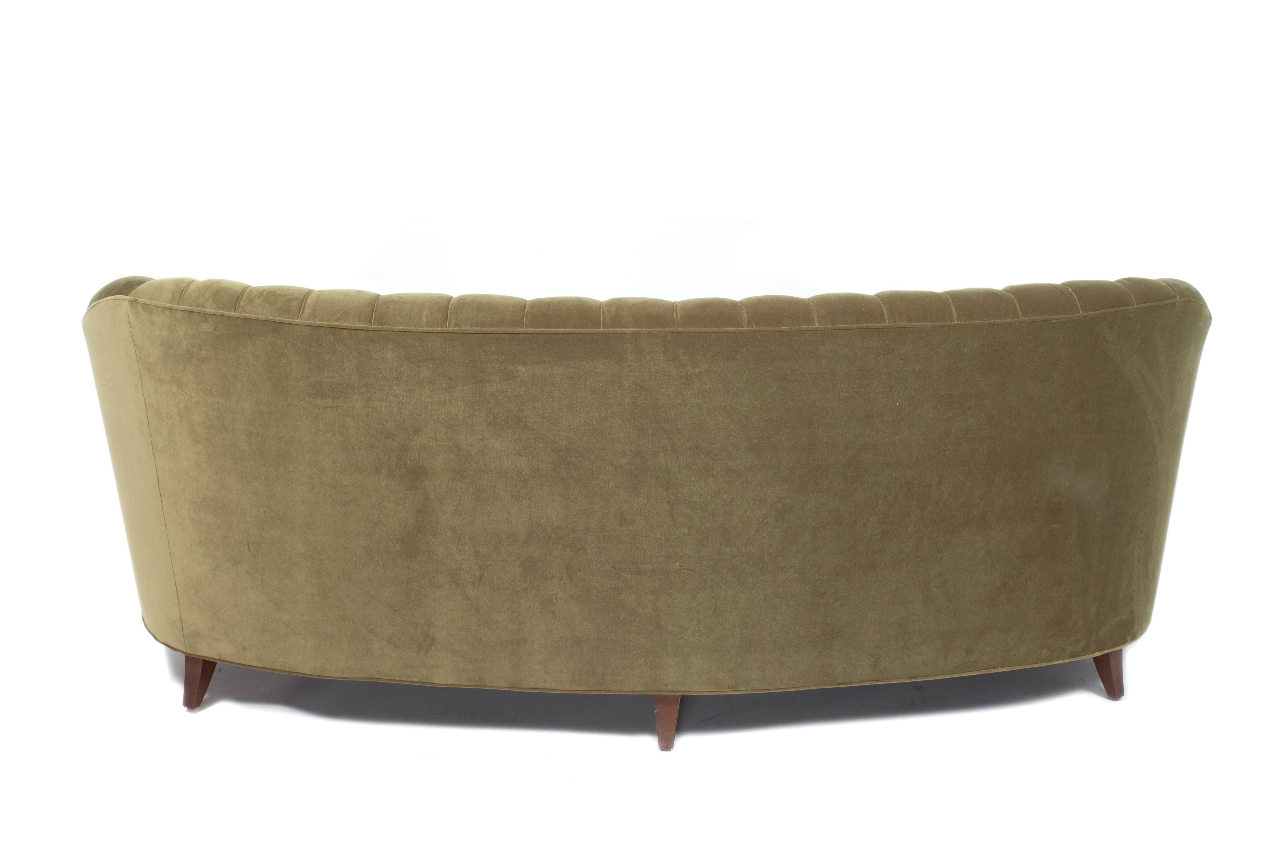 French scalloped and tufted curved sofa beautifully upholstered in green velvet. Three loose seat cushions.