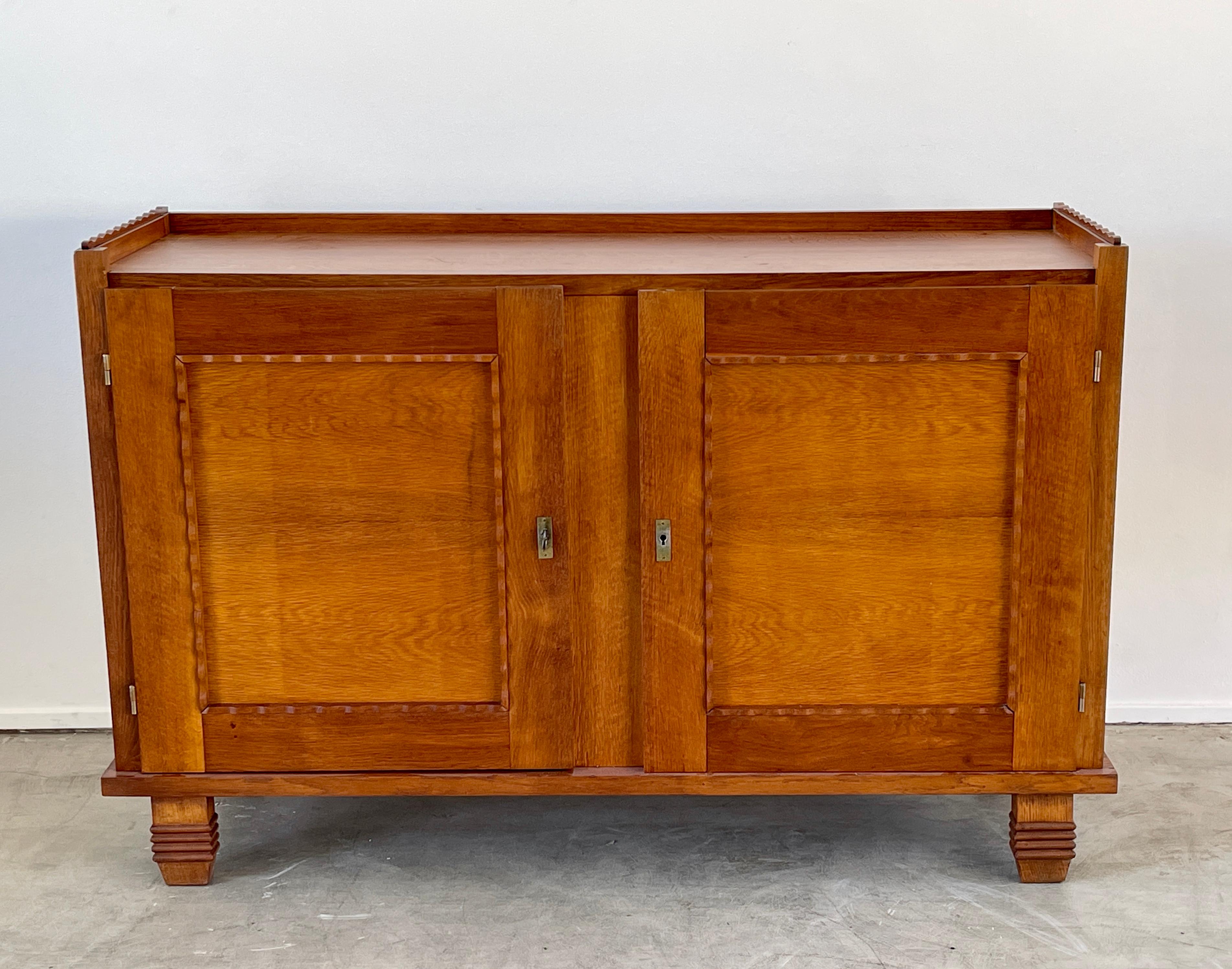 1950's French oak sideboard with scalloped edges and incredible lines. 
Cabinet has 2 doors with original key - open shelving 
Wonderful patina to wood.
   