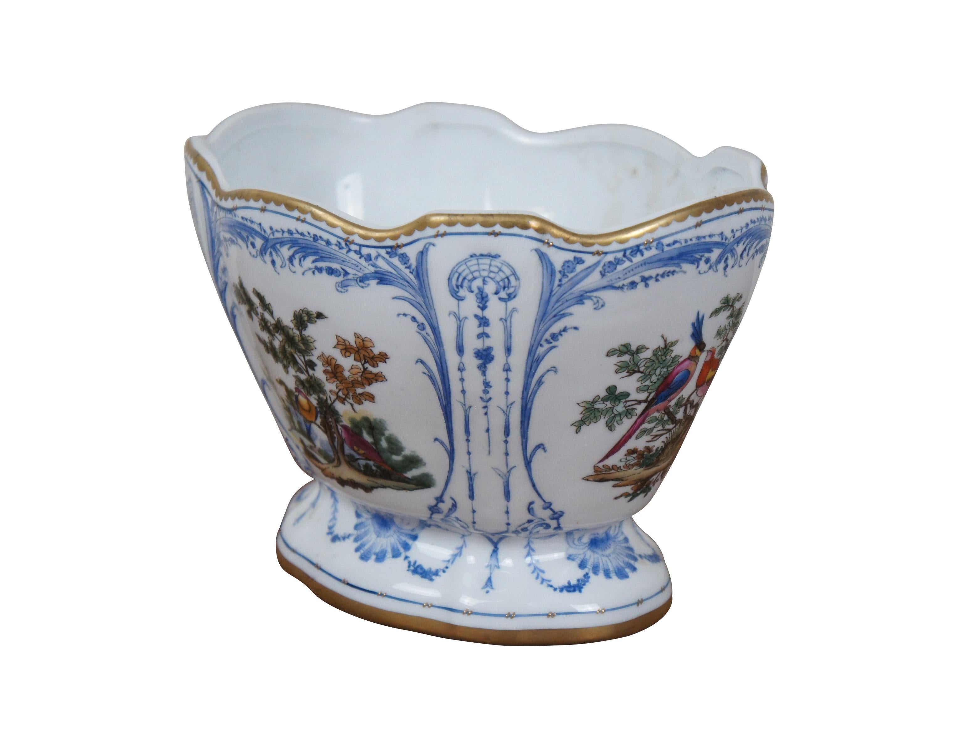 French Desvres style porcelain planter / jardiniere / cachepot / compote / footed centerpiece bowl - oval form with scalloped, gilded edge, tapering to a flared base. Hand painted with delicate blue frames around brightly colored birds on small