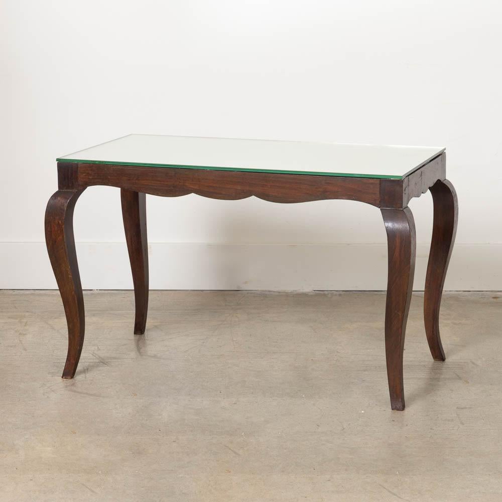 Wonderful wood table with mirror top from France, 1940's. Rectangular top with newly replaced mirror on wood frame with scallop detail and carved legs. Perfect as a small console table or side table. Original dark wood finish shows great age and
