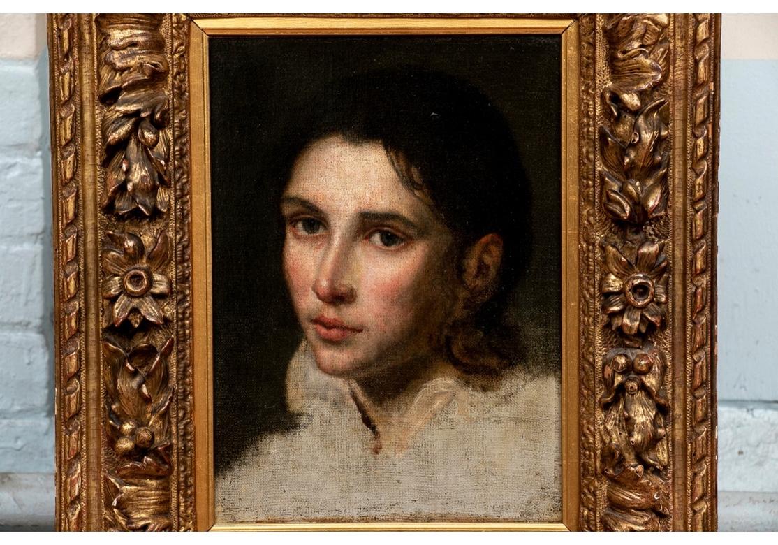 Fine antique portrait in carved and gilt frame. Christies label on verso- 29 Nov.-05, sale 1577, lot 650.
3/4 portrait study of a youth with black hair wearing a white shirt with ruffled collar, on a black background. He looks out to the viewer in
