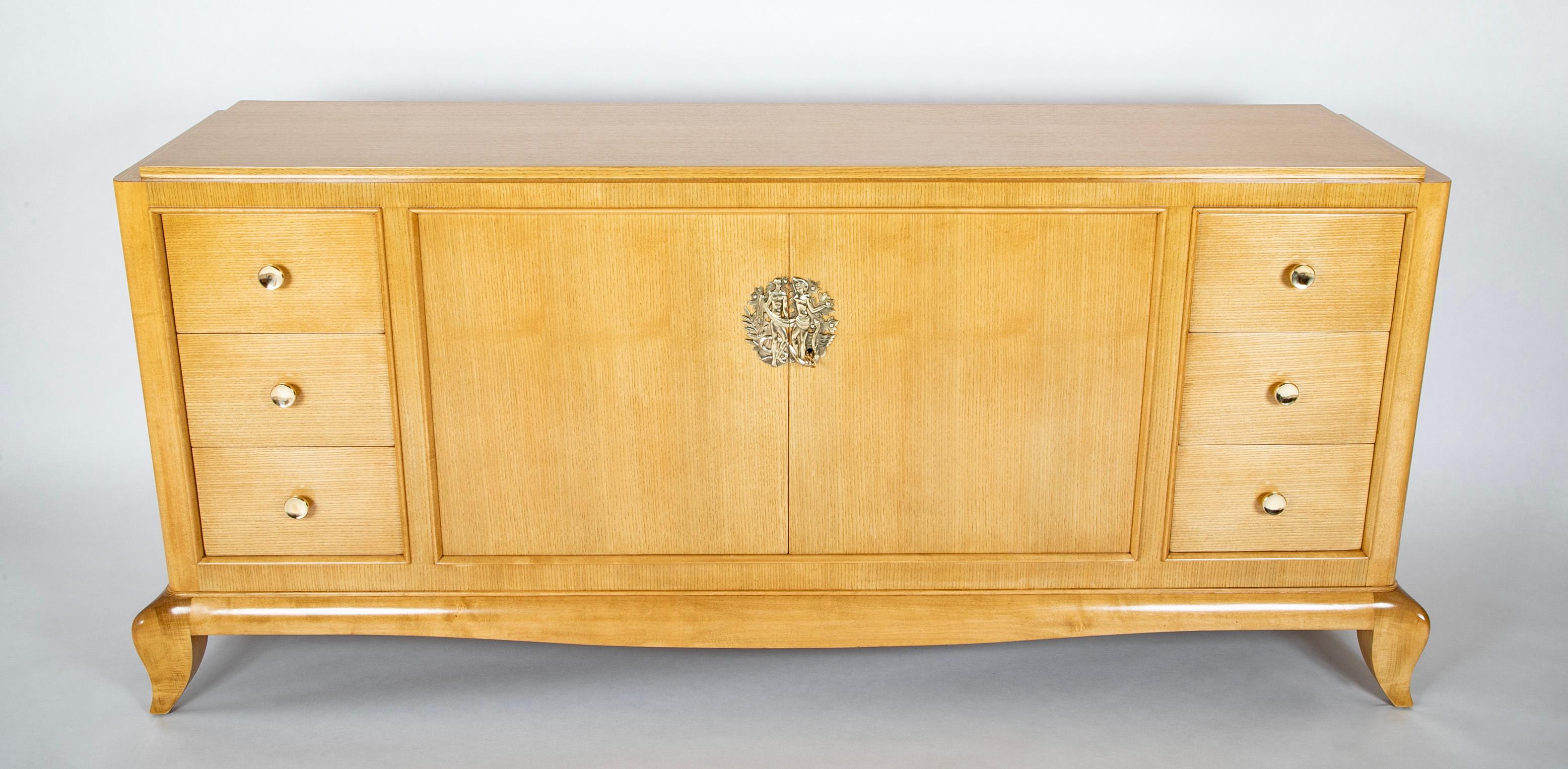 French School of Arbus 6 drawer credenza in veneered light wood with 2 center doors and Adam & Eve Medallion.   Circa 1940's.