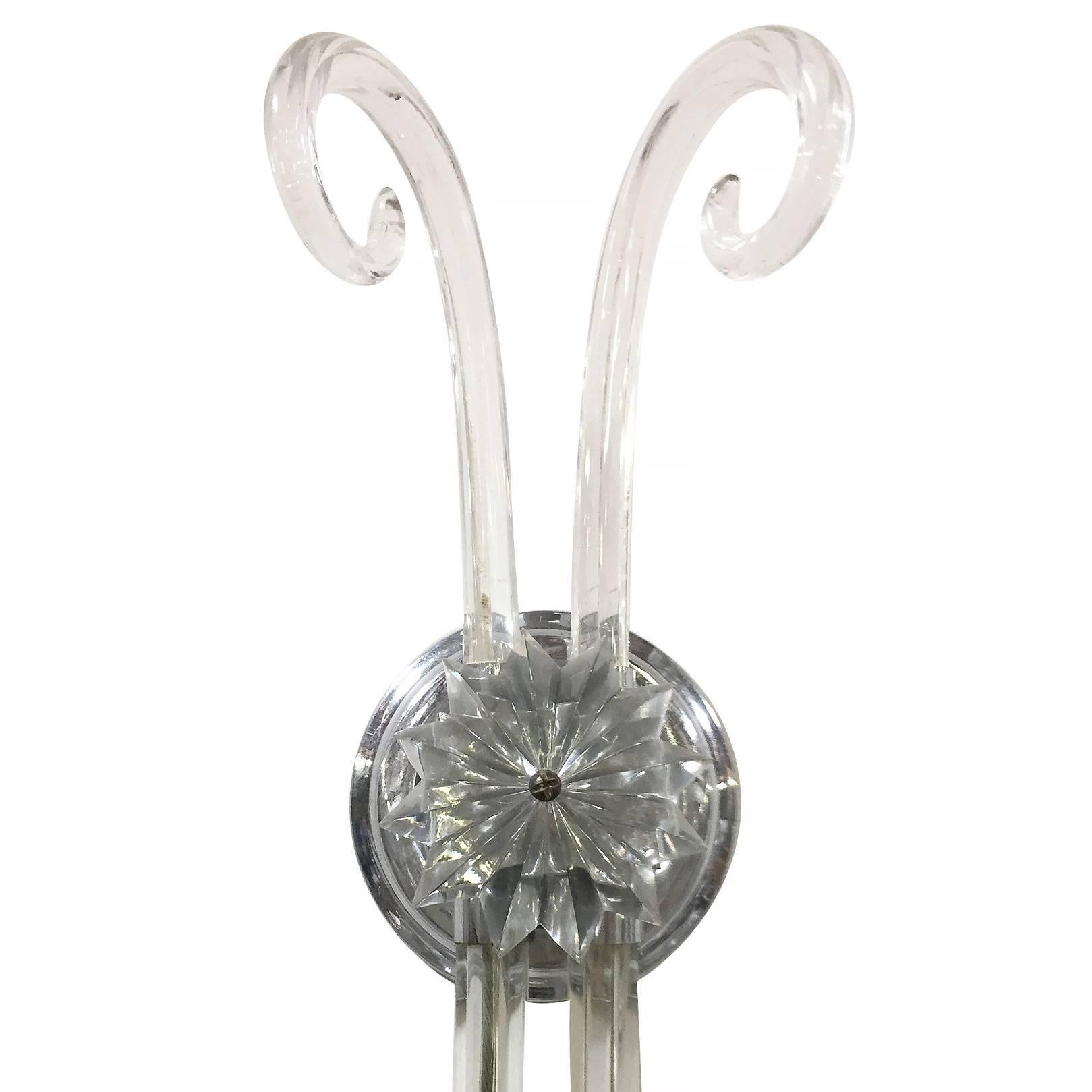 Beautiful pair of wall sconces featuring a pair scrolled crystal arms. The wall mount is adorned with a crystal cut flower.