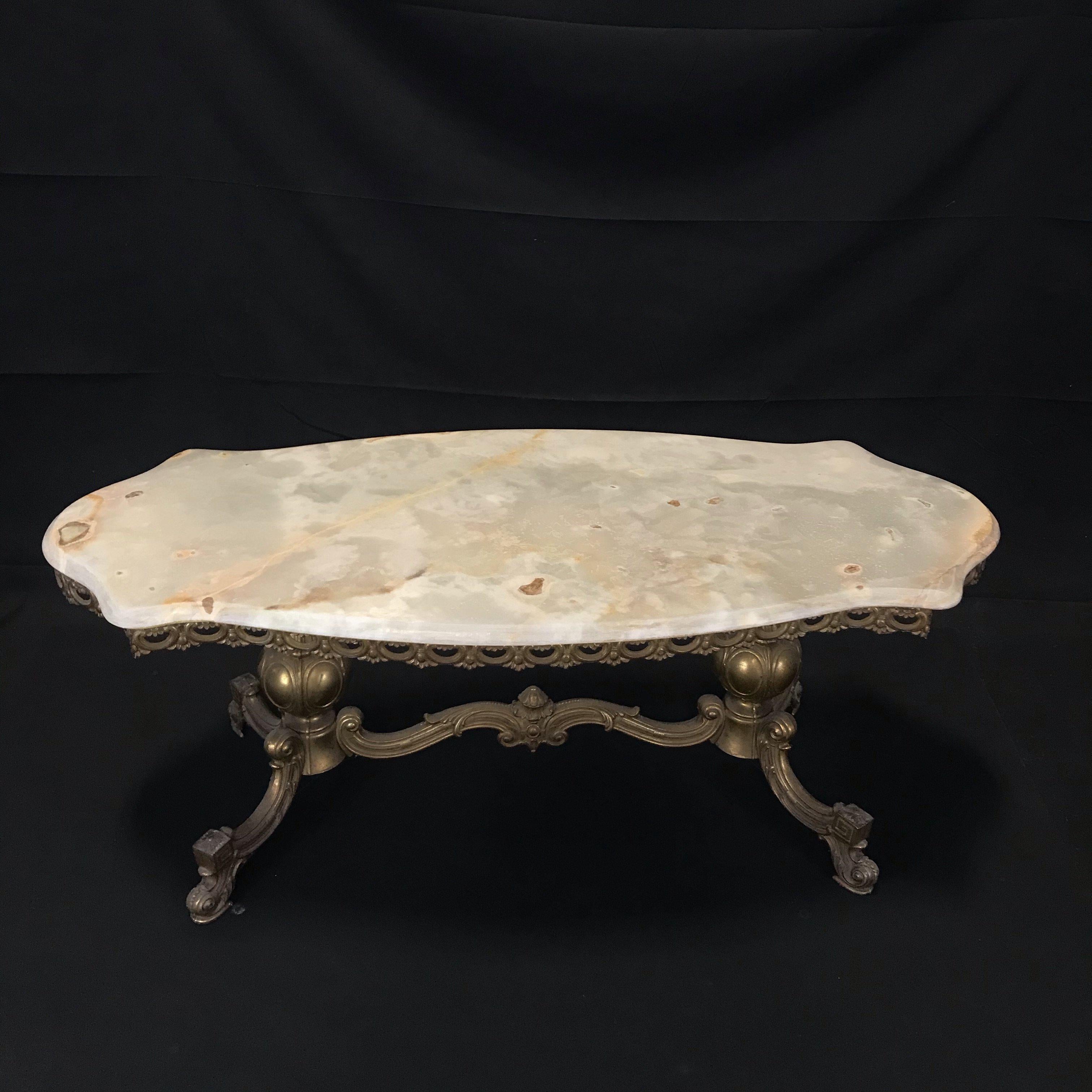 Lovely scalloped oblong French marble top coffee table with a classic bronze base. 
#5021.