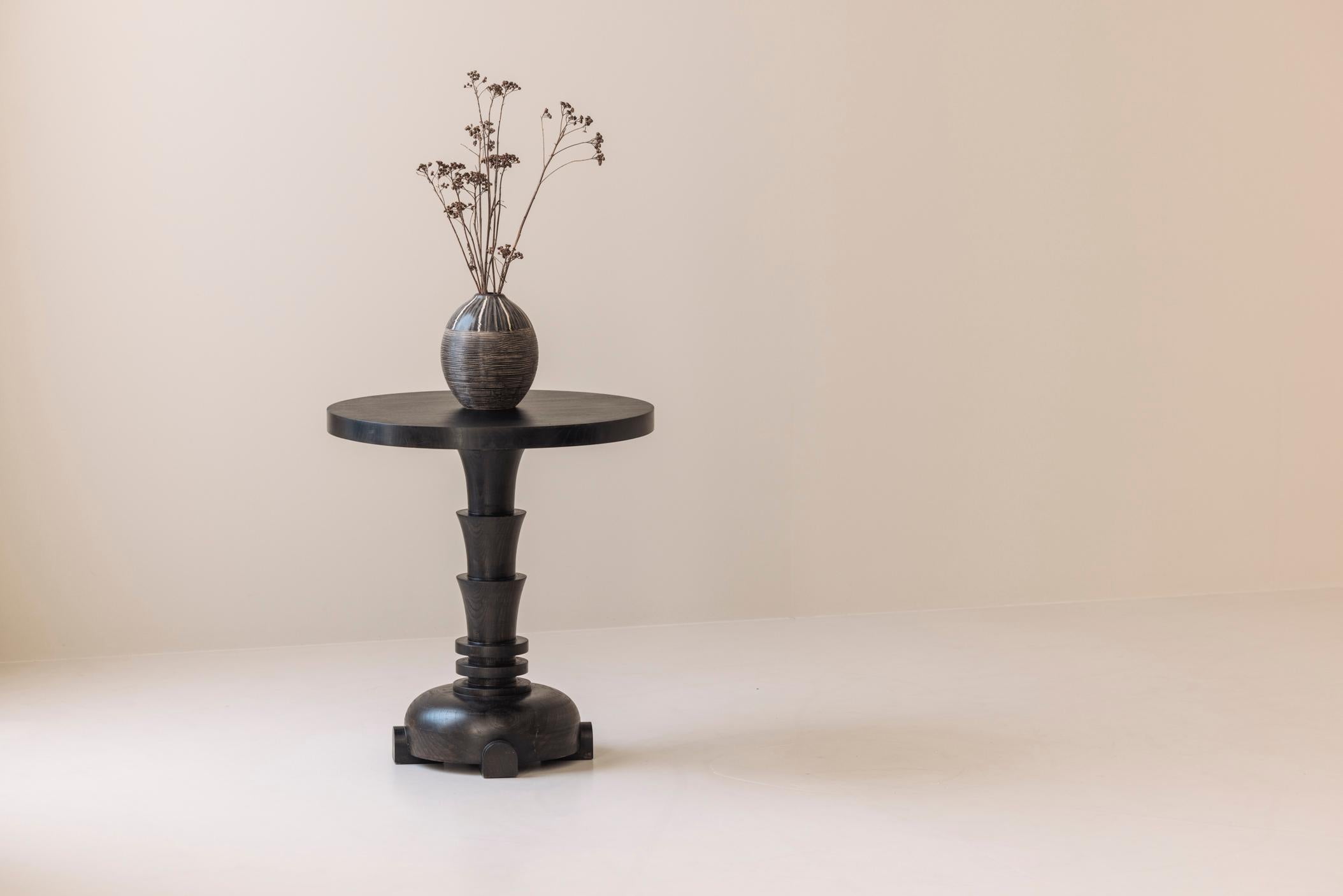 A French sculptural dark stained side table from the 1980s, thoughtfully designed in the spirit of Art Deco. With its bold silhouette and rhythmic geometric forms, this piece captures the elegance and drama of the Art Deco era while embracing a more