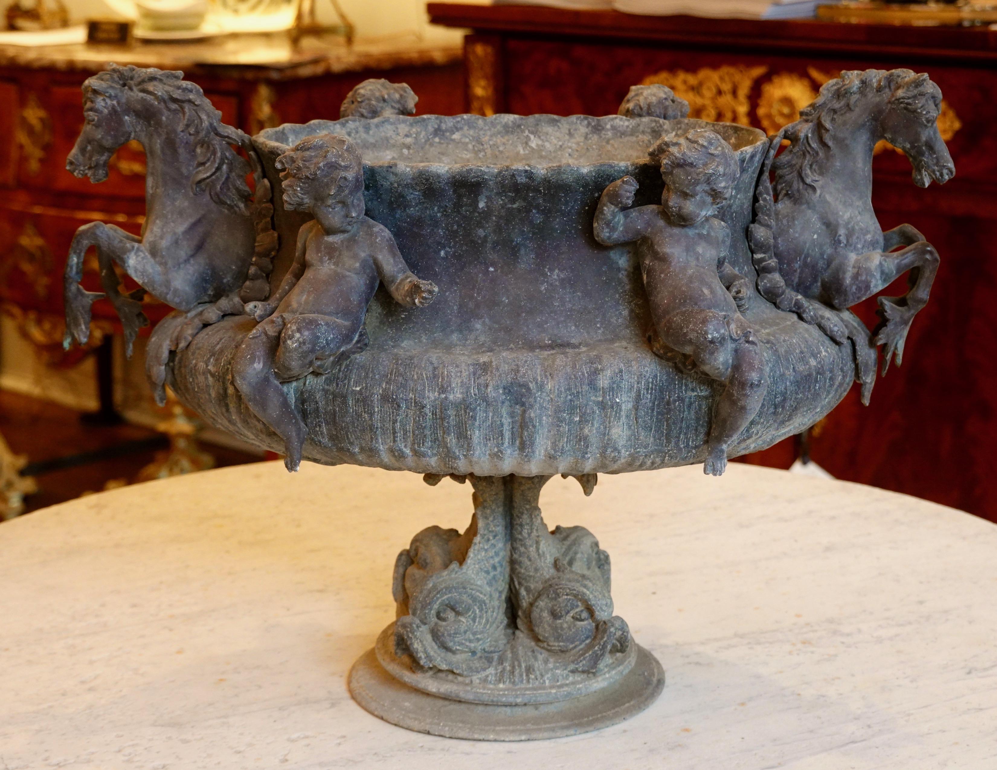 A rare and highly-sculptural French 19th century jardinière with two putti flanking each side, a hippocampus (mythical sea horse, which is typically depicted as having the upper body of a horse and lower body of a fish) decorating each end,