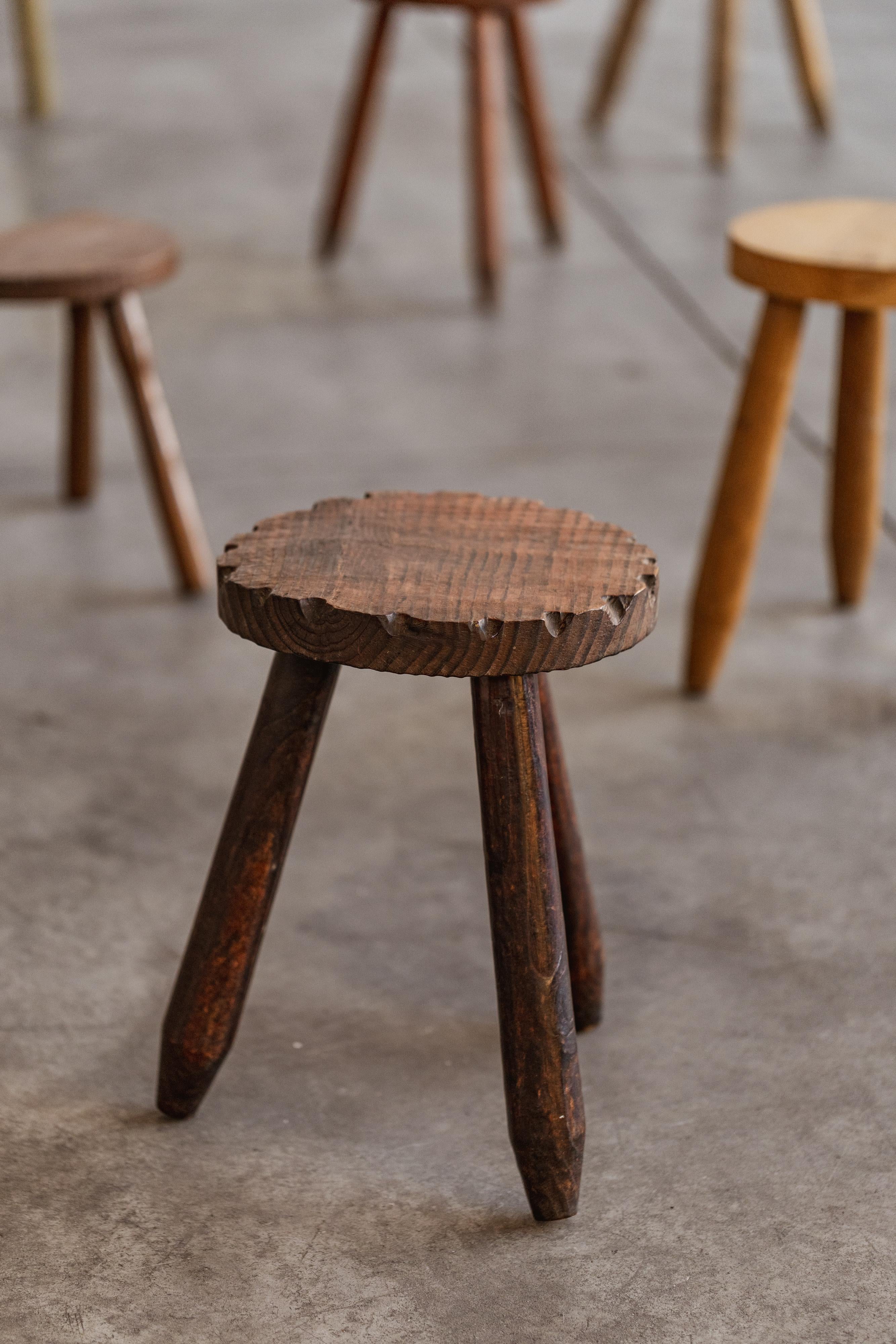French Sculptural Primitive Stools, wood, 1960, set of five.

This collection of hand-carved stools originates from rural France, dating from the 1960s. Each piece is a microcosm of functional imperfection: uneven seat planes, worn edges, and
