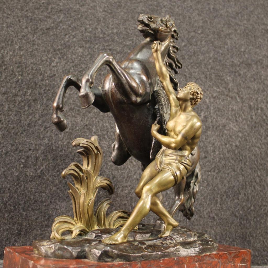 French sculpture of the mid-20th century. Object in bronze gold and patinated depicting Marly's Horse, copy of the famous sculpture in marble by the sculptor Guillaume Coustou desired by Louis XV around the middle of the 18th century. Work resting