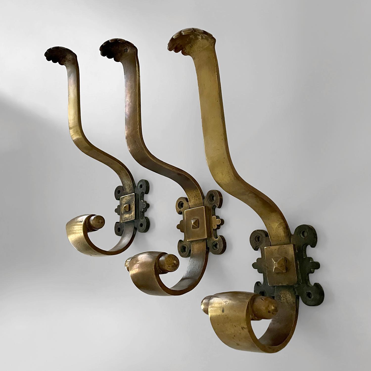 French aged bronze studded wall hooks
France, 19th century 
Handcrafted artisanal pieces
Heavy in weight and substantial in their construction and composition
Sculpted aged bronze J hook has an upper hook with a wonderful scalloped edge 
The lower