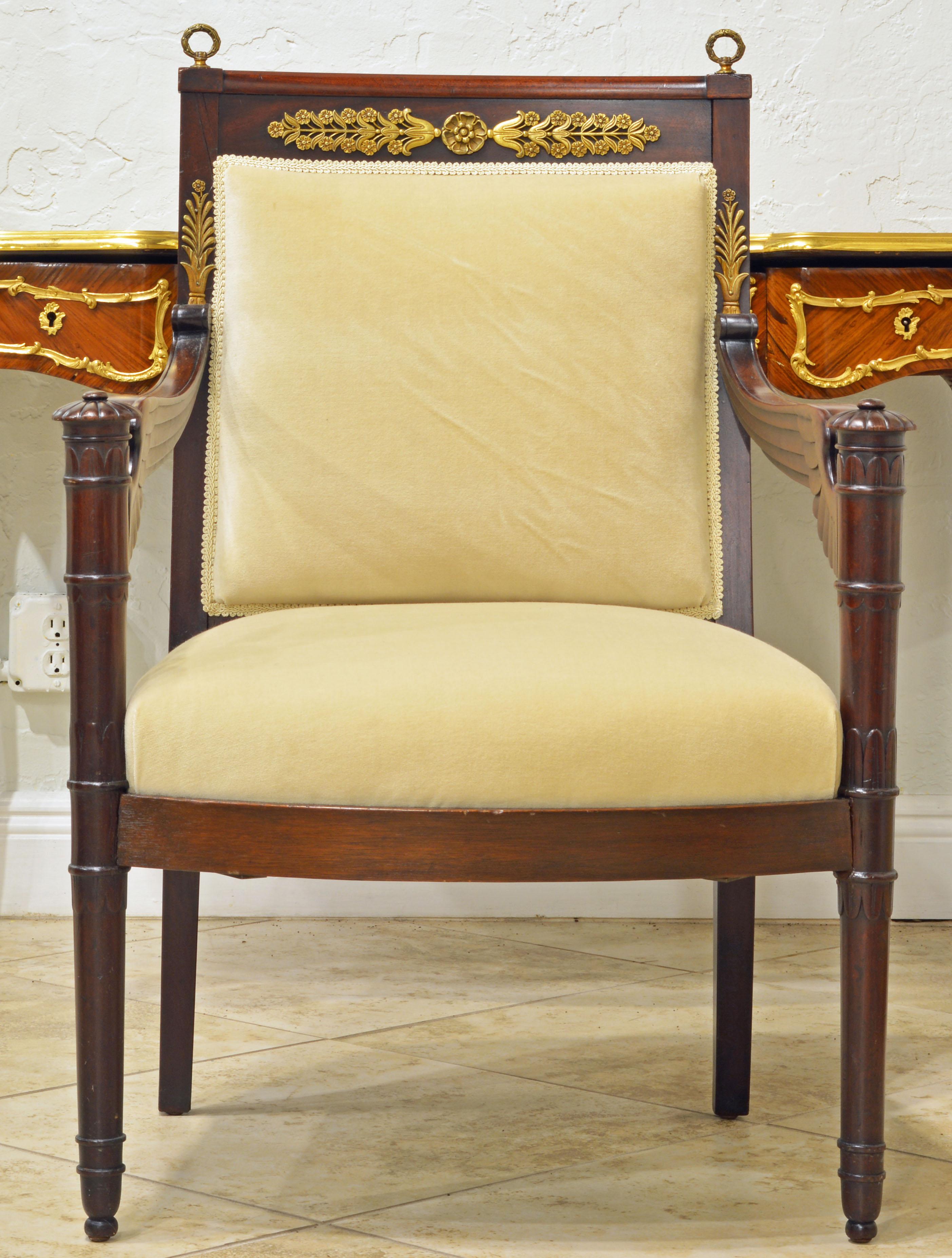 This elegant carved mahogany armchair resting on small casters dates to circa 1870 a time when Napoleon III was Emperor of the French. He adopted many of the stylistic elements first seen during his uncle's Napoleon I reign. The chair features