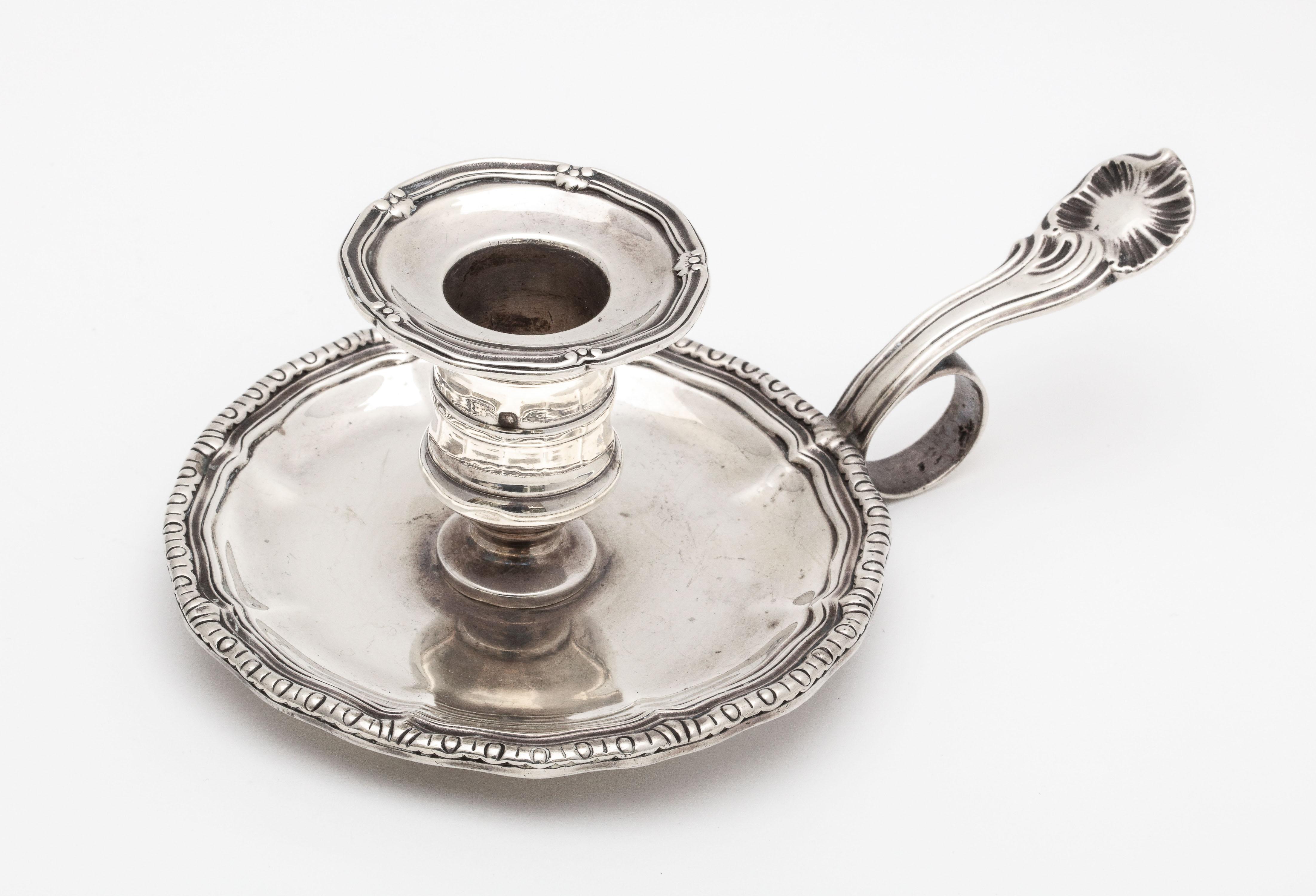 French, Second Empire, sterling silver chamberstick, Paris, circa 1850s. Measures 6 1/2 inches wide from edge of handle to far edge of tray x 2 3/4 inches high x 4 inches diameter. Weighs 7.050 troy ounces. Tray is attached to candleholder with a