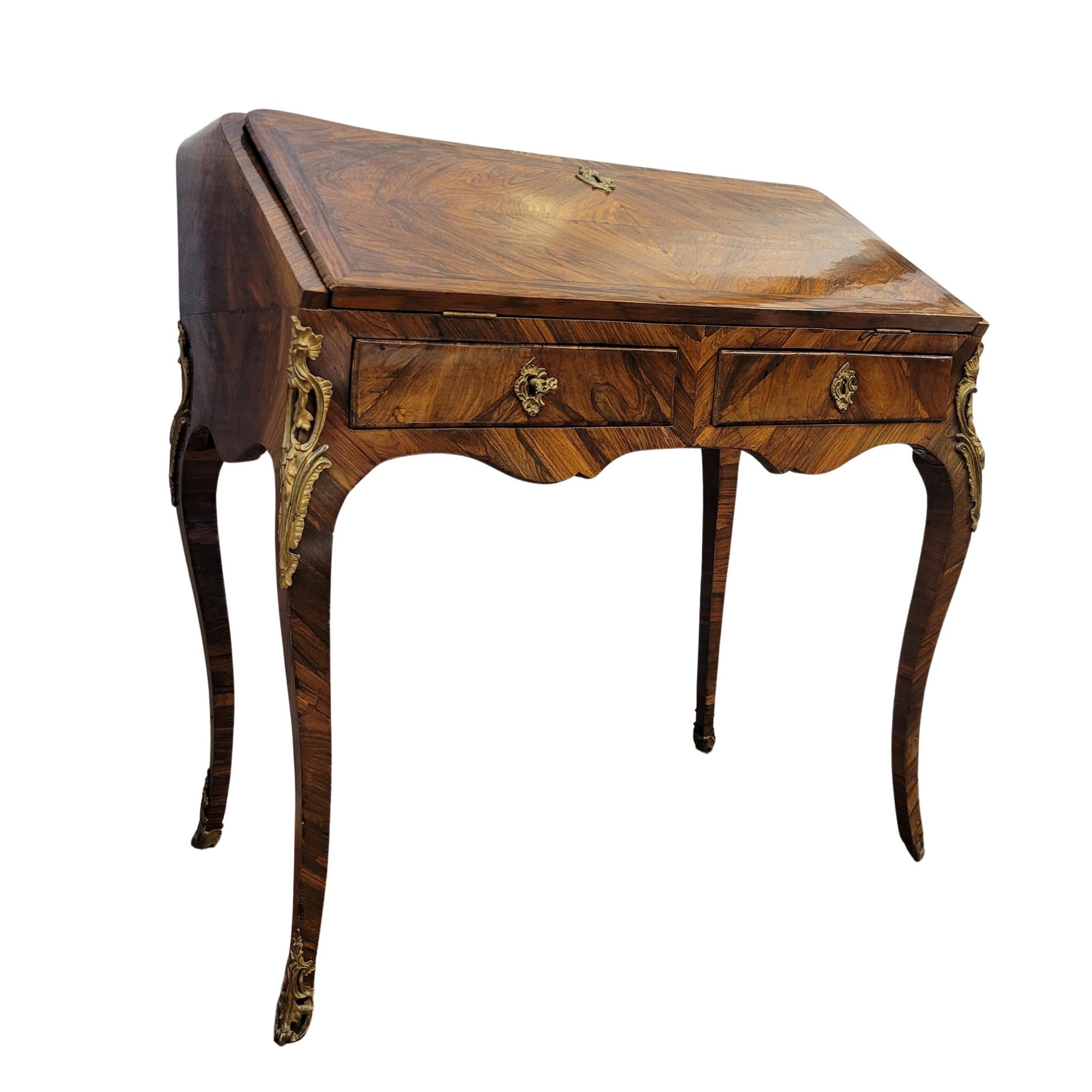 One of a kind and very refined French piece ,  a Louis XV Bureau à Pente / Secretaire ,made in France at the beginning of the 19th century. Entirely veneered in extraordinary precious wood , which combines its grains to create subtle ornaments. It