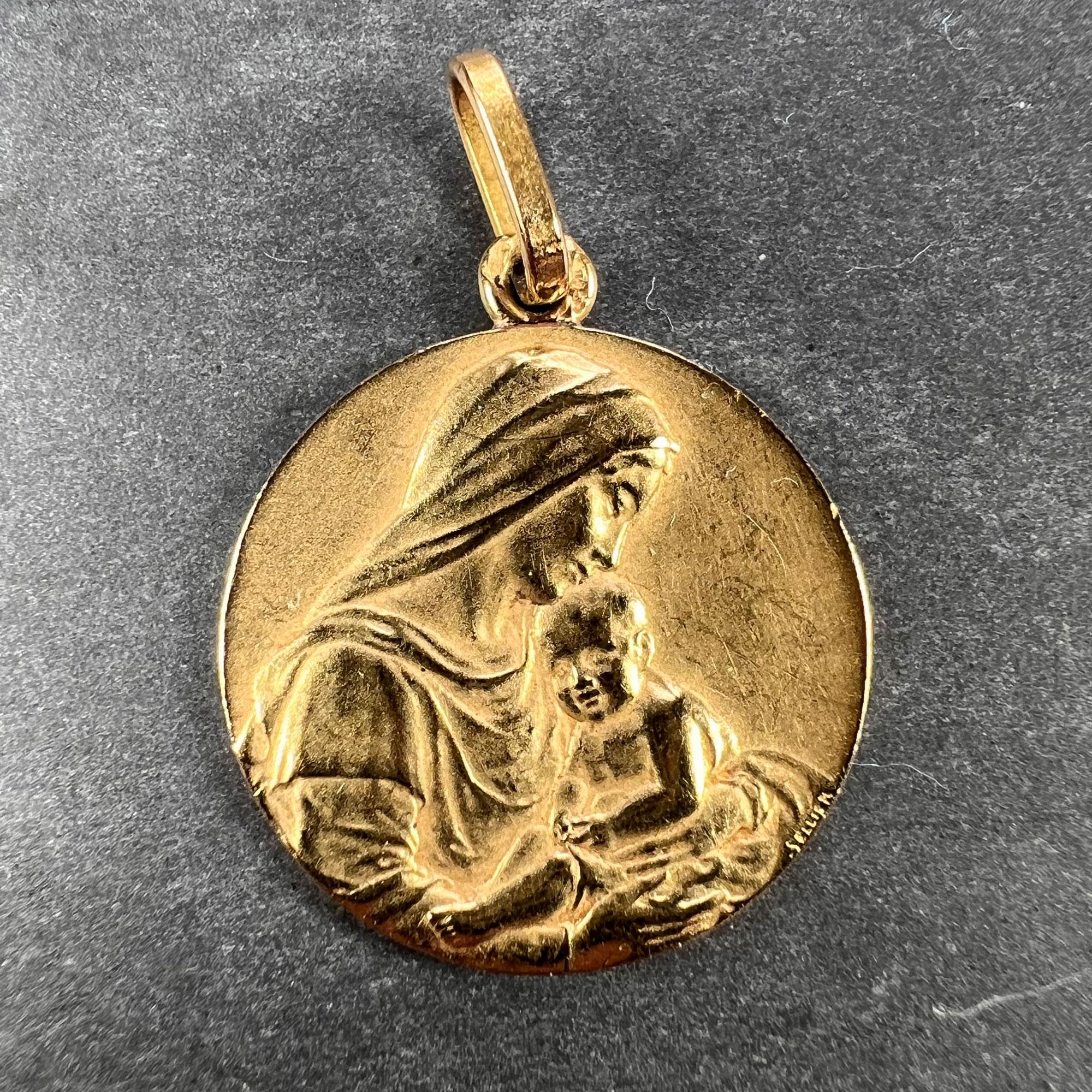 A French 18 karat (18K) yellow gold charm pendant designed as a medal depicting the Madonna and Child signed by Sellier. Stamped with the eagle’s head mark for 18 karat gold and French manufacture, and an unknown maker’s mark.
Dimensions: 2.2 x 1.8