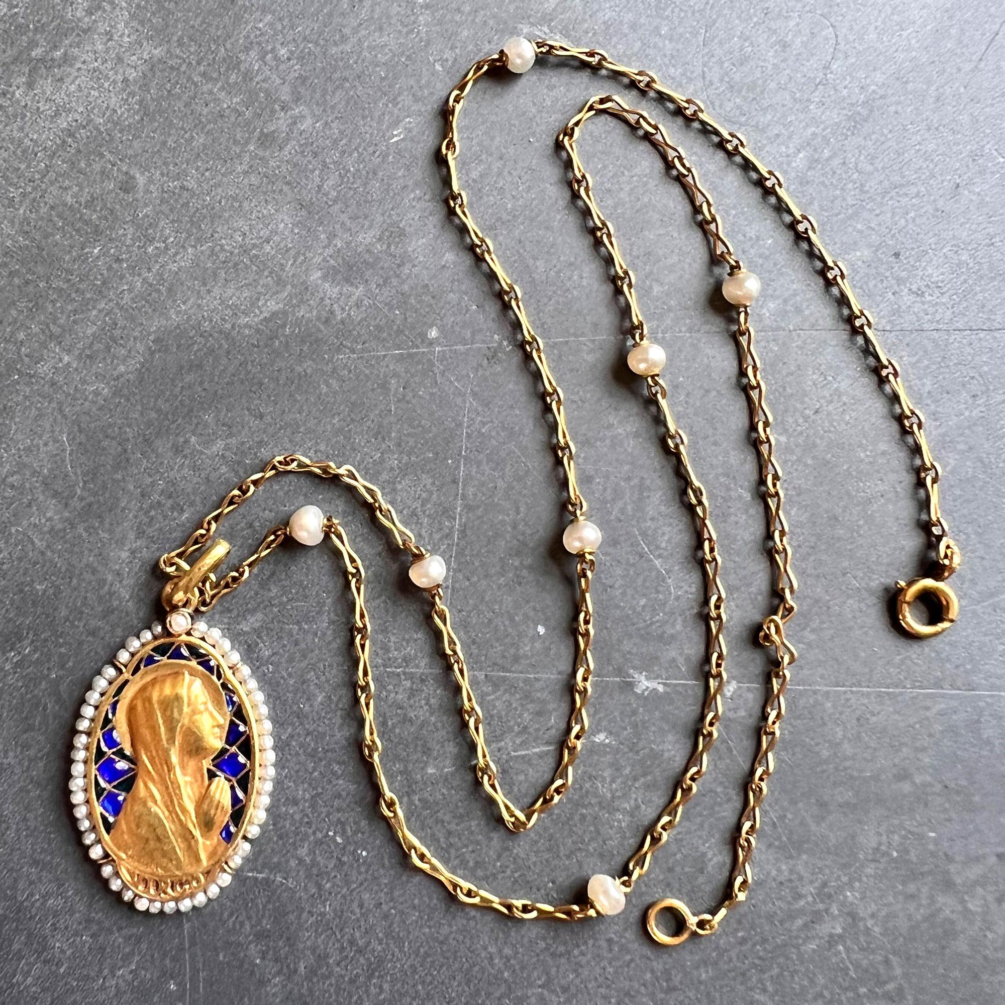 An 18 karat (18K) yellow gold pendant designed as a medal depicting the Virgin Mary with plique-a-jour enamel, a rose-cut diamond and surrounded by 46 natural seed pearls. Signed Sellier and engraved ‘VIRGO’. Stamped with the eagle’s head for French