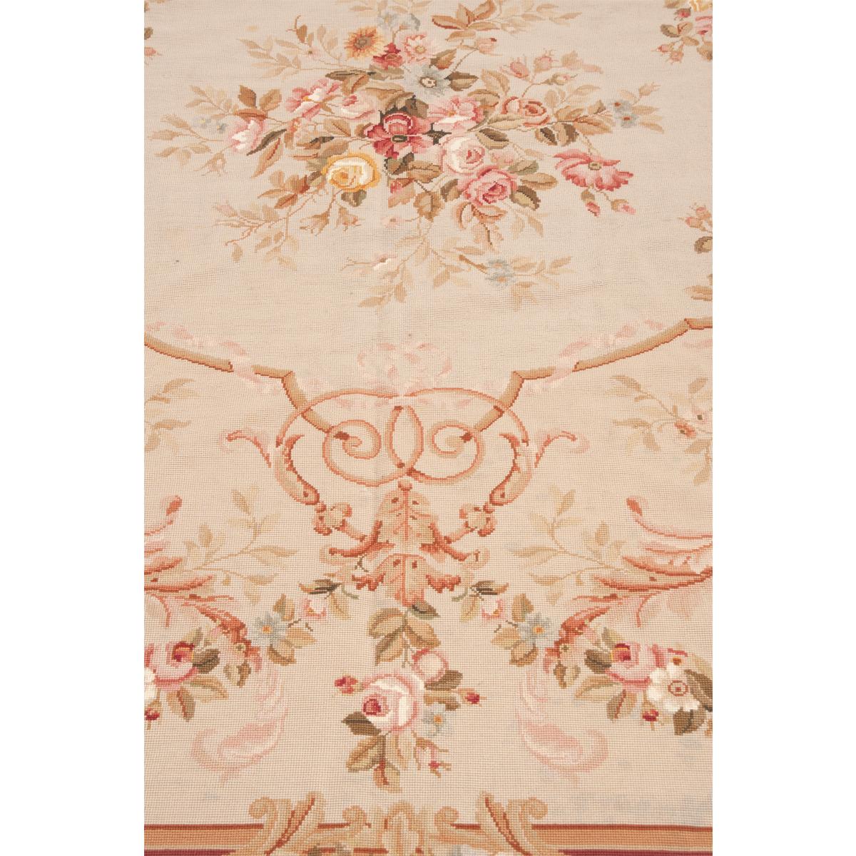 Beautiful example of an Aubusson rug. A fantastic display of floral and scroll designs, handwoven from France. Tons of earth tone colors: browns, greens, beiges, rust/reds, mauve/pinks and more are all in soft shades. See detailed pictures for