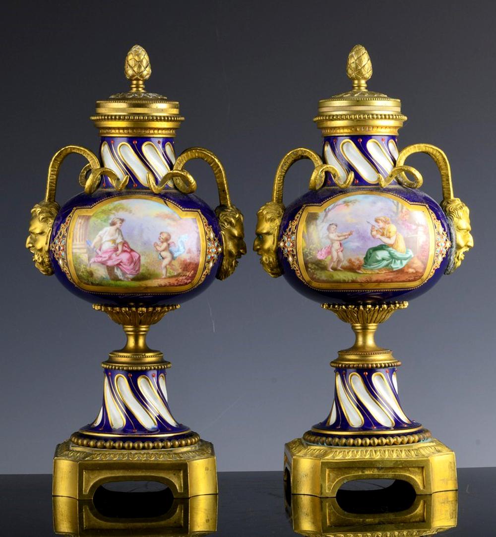 French Serves-style porcelain & gilt bronze ormolu cassolettes urns,
Circa 1880-1900

The French porcelain ormolu bronze mounted cassolettes urns have finely hand painted landscapes on one side and scenes in the Boucher style with figures on the