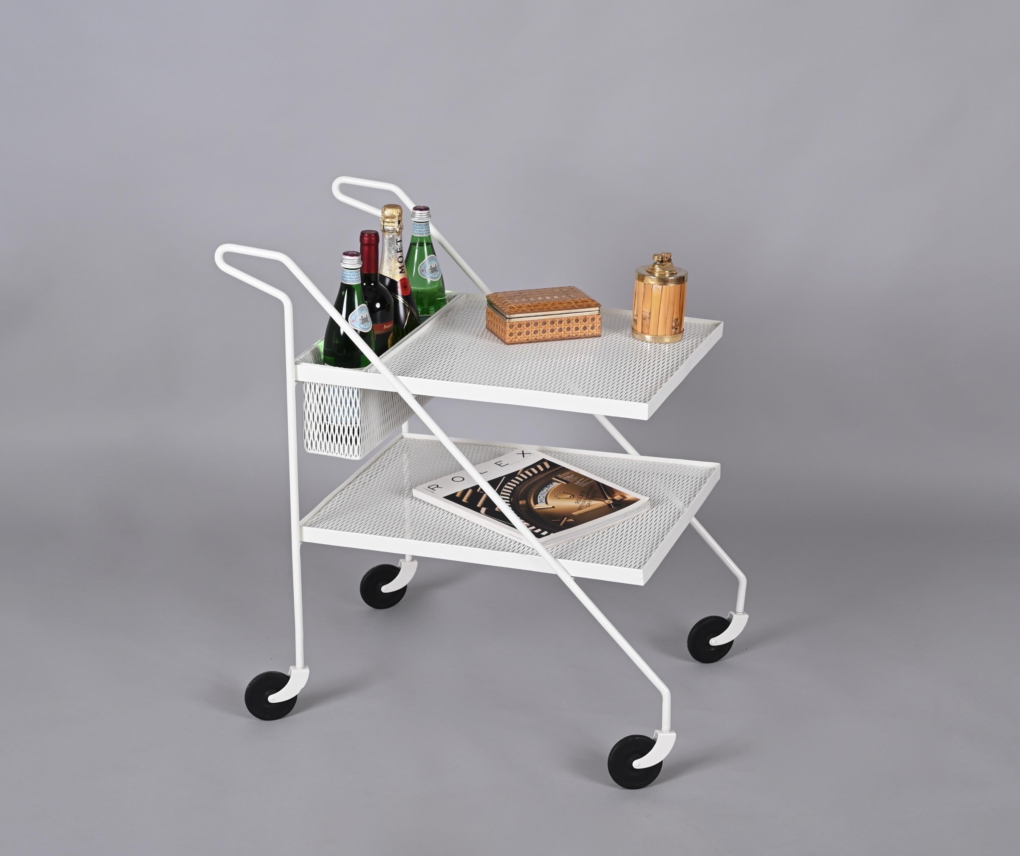 Lovely serving bar cart in perforated enameled iron with a removable top bottle holder. This gorgeous piece was realized in France in the 1970s, clearly in the style of Mathieu Matégot.

The curved handles together with the perforated iron trays and