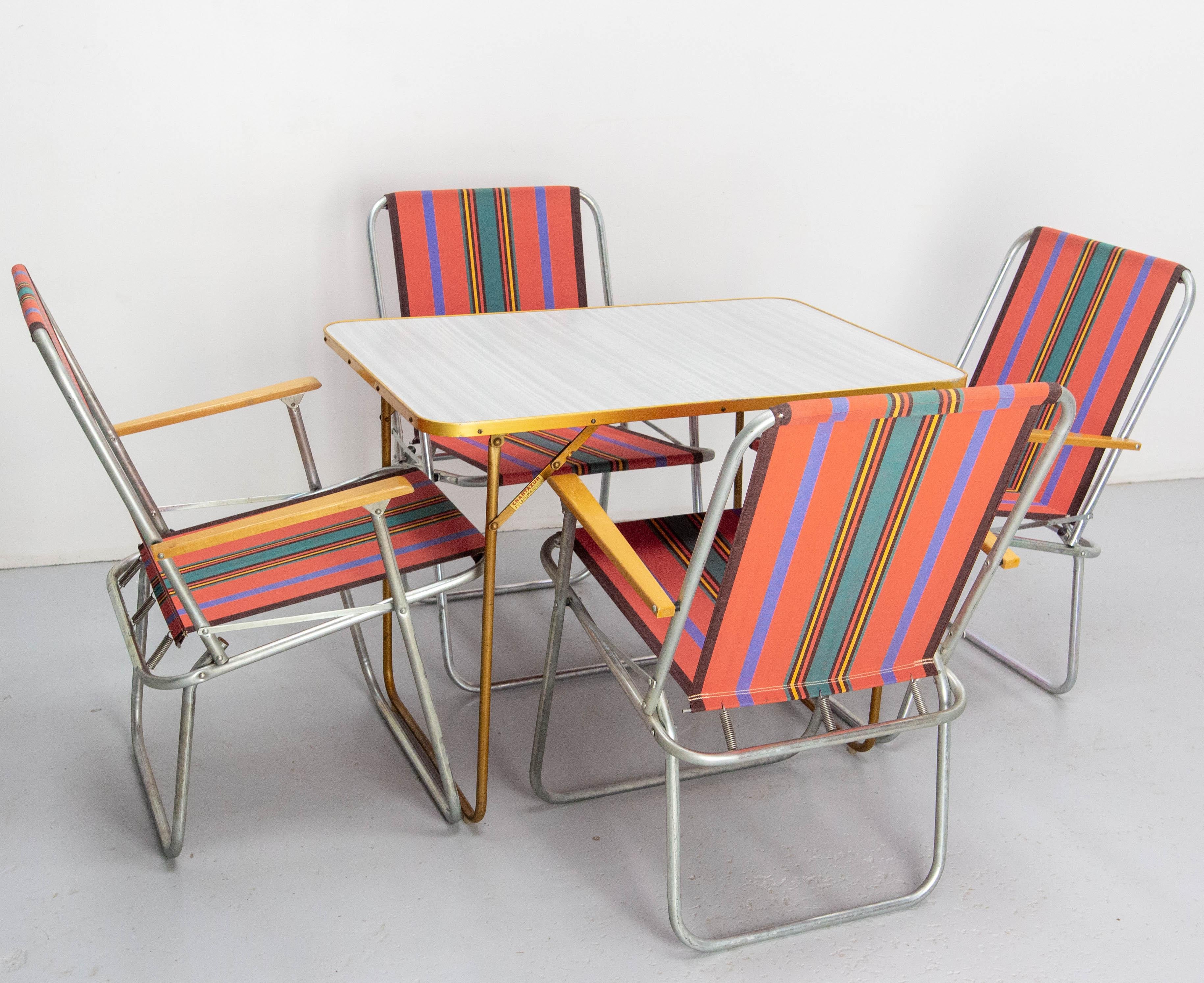 French folding four chairs and table, typical of the fifties, brand Chantazur Lafuma.
Good condition patina the fabric is the original and it is in very good condition.
Each piece is fold-able.
Dimension: 
chairs: D 24.41, W 22.05 H 31.50 in. Seat H