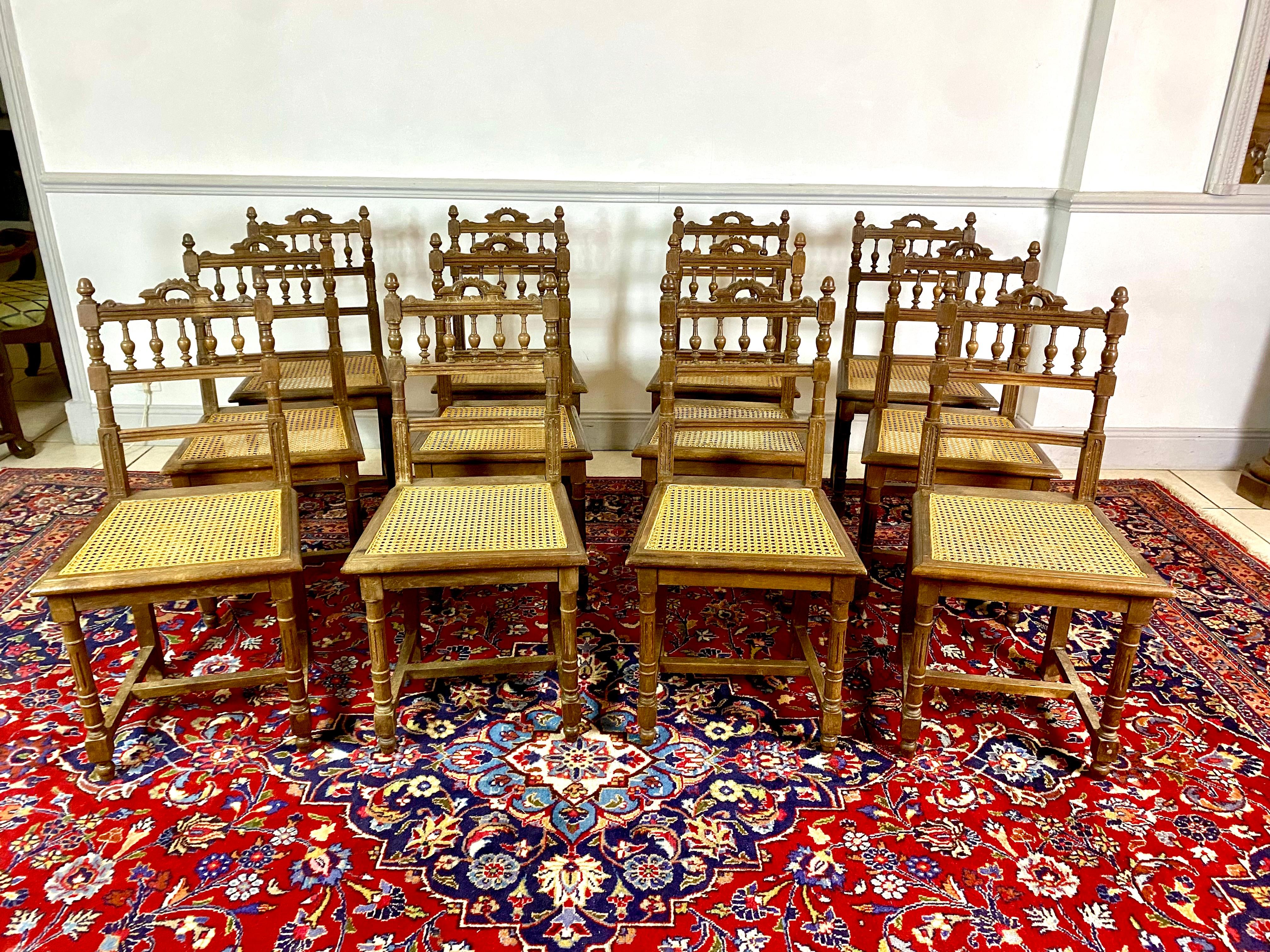 Set of 12 Henri II / Renaissance style caned oak dining room chairs from the Neo-Renaissance period.
The seats are entirely made of cane in good condition, the canage.
The backs of the chairs are richly carved with architectural motifs, mainly