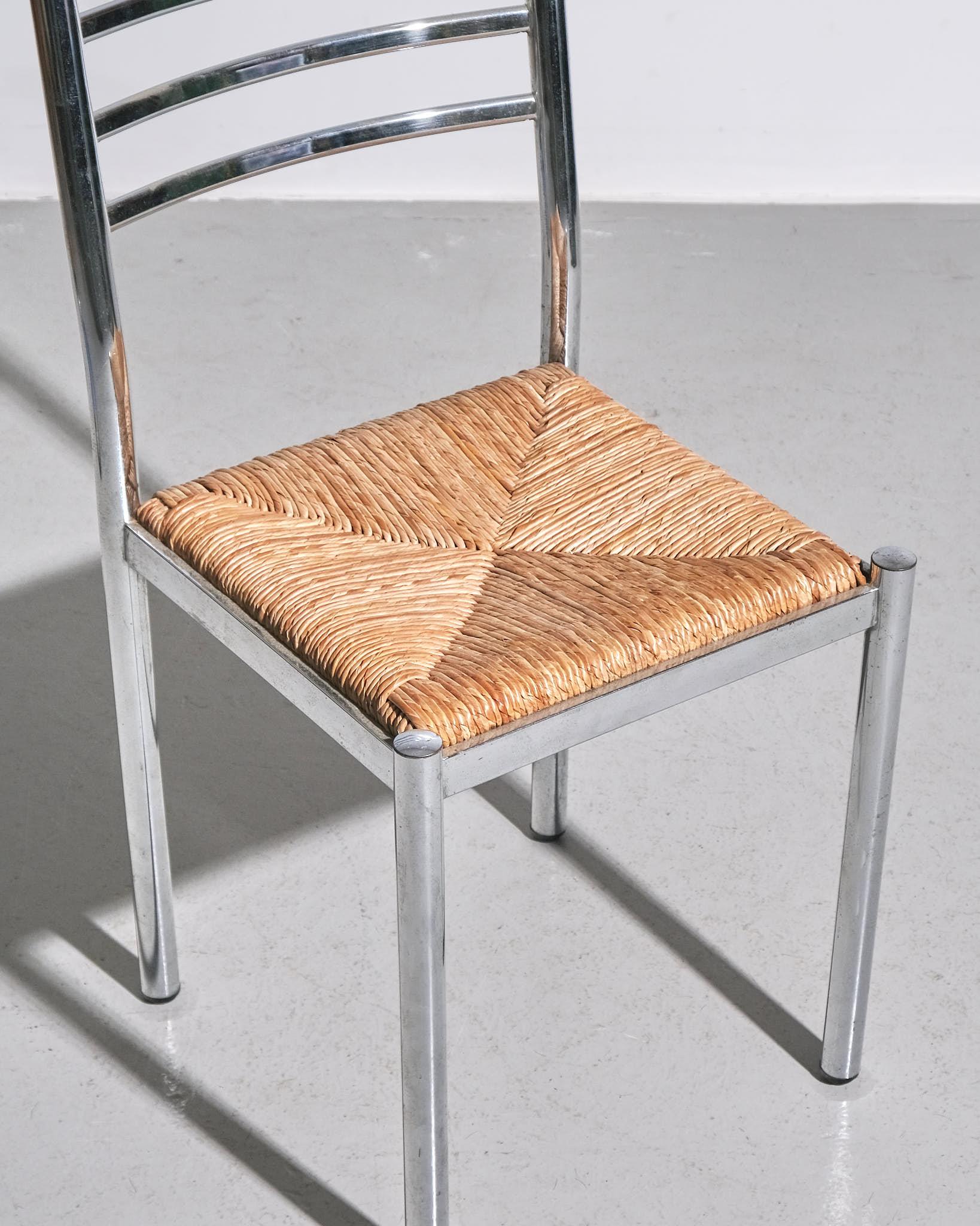 Set of Four French Metal Dining Chairs, c. 1960s

A set of four French dining chairs from the 1960s, featuring a chrome-plated metal frame with a ladder-back design. The seats are rush, adding a natural contrast to the sleek metal structure. The