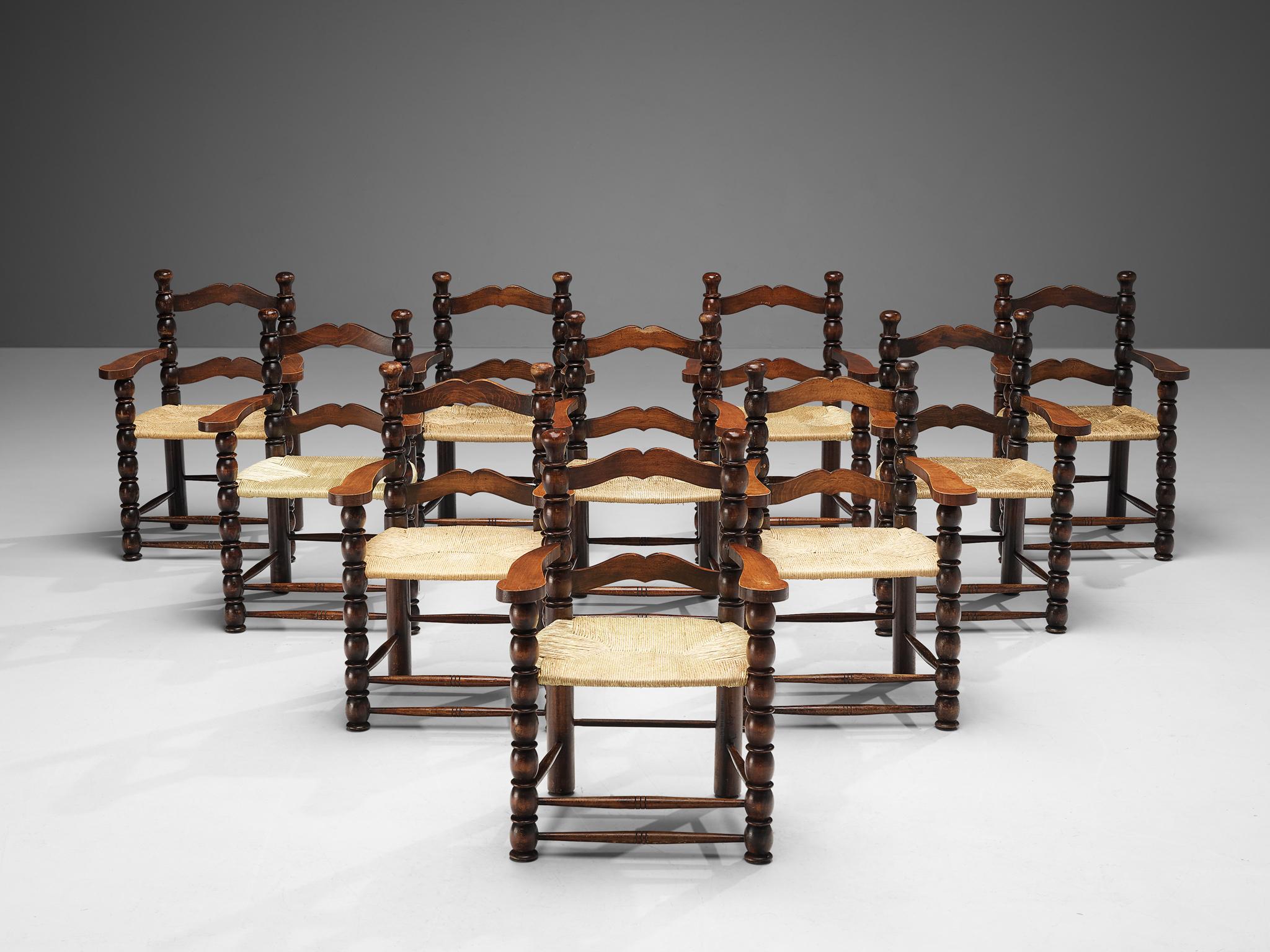 Armchairs, stained wood, straw, France, 1940s.

Decorative set of French armchairs. The stained wooden frame has multiple carved details that add up to a complex whole. Carved lines and circular ends, straight and round parts come together to form a