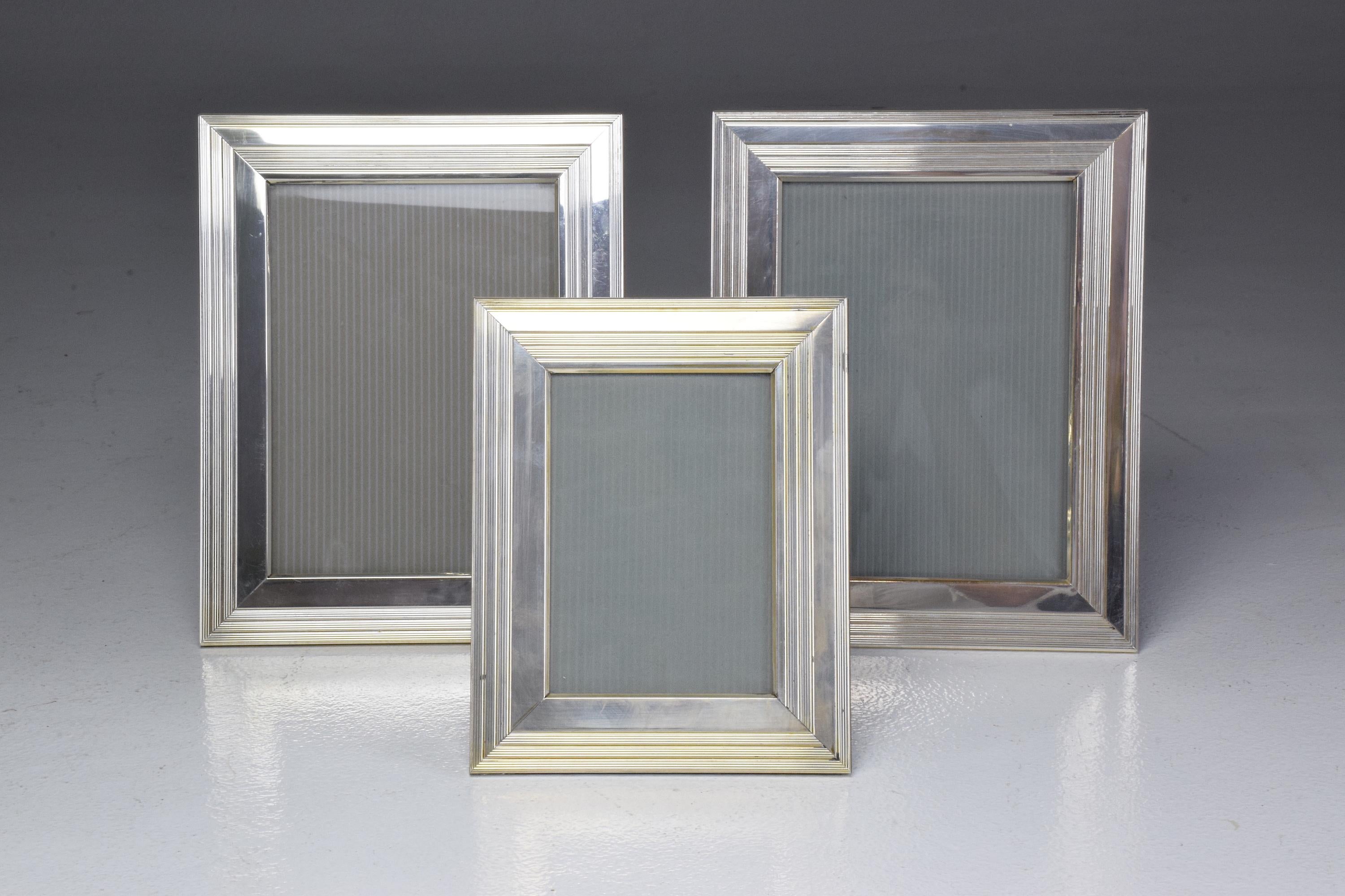 A 20th century vintage set of three rectangular silvered metal picture frames with a varnish finish and wood in reverse. Stamped and signed Christofle. 
France, circa 1960s-1970s. 
Two of same size measure 24cm in height and 19cm in width 
Smaller