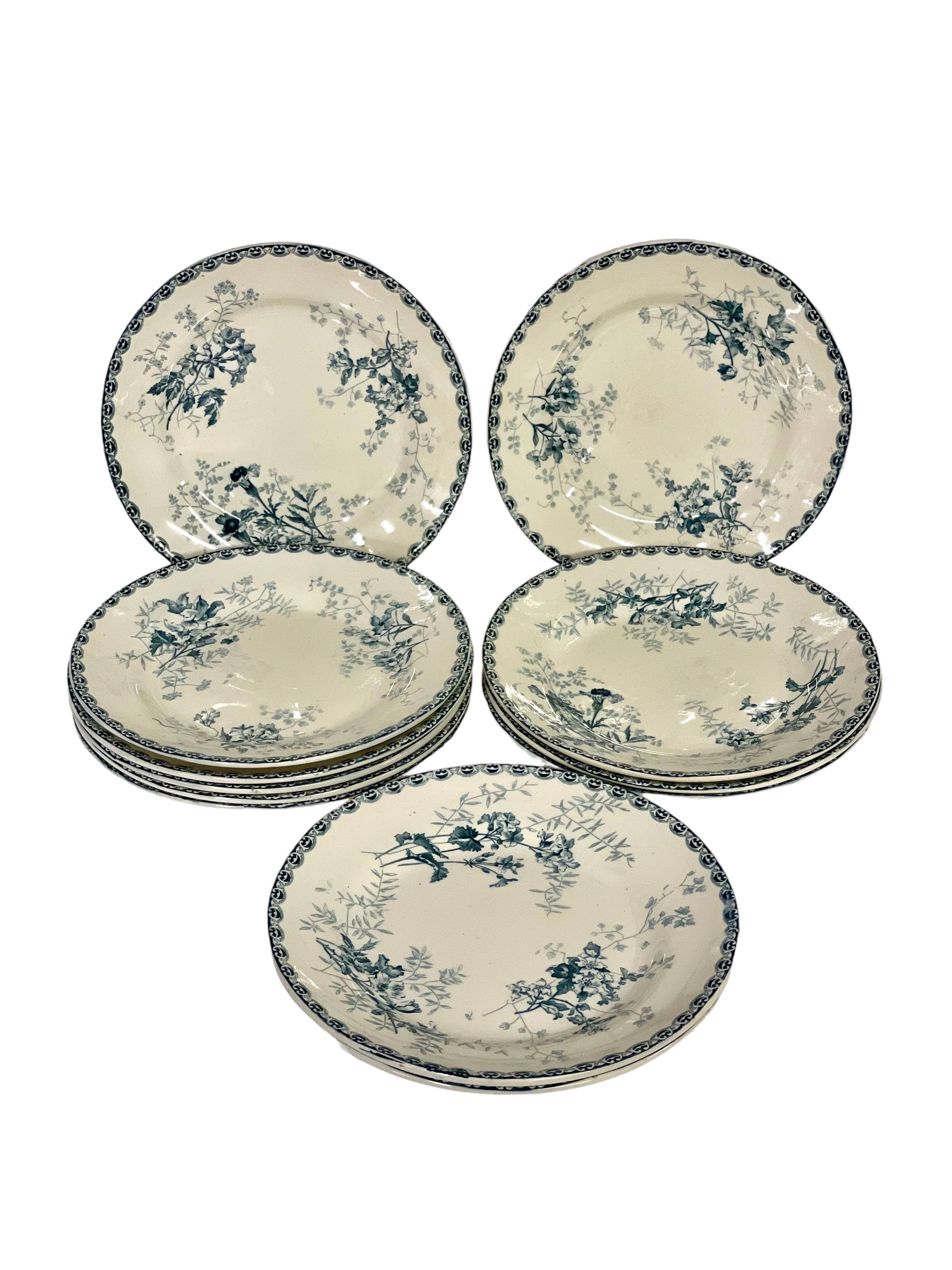 A gorgeous set of twelve antique French ironstone ('Terre de Fer') dinner plates, featuring a wonderful hand-painted transferware decor of blue and white wildflowers. In very good, vintage condition for their age, with no cracking and little to no