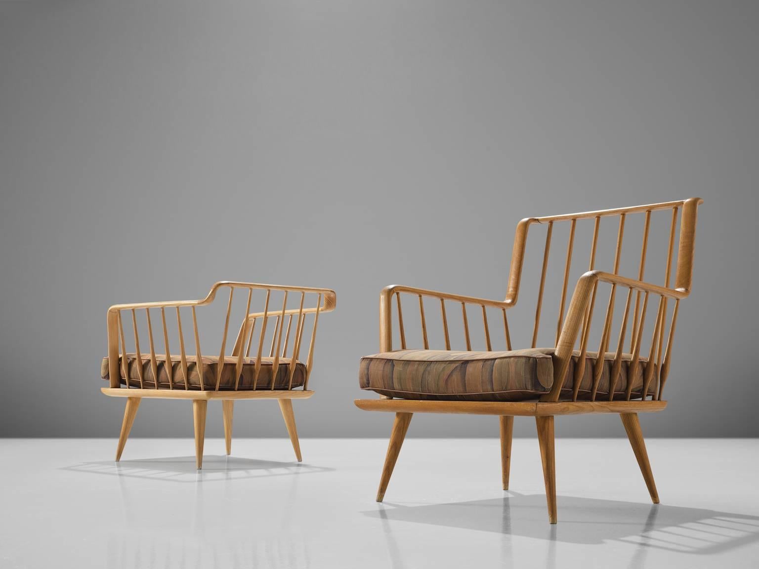 Lounge chairs in oak and fabric, France, 1960s

This set has a very sculptural, open frame. The tapered legs hold the slatted baskets and have a flowing shape. The chairs are airy and work well with our without a pillow. The chairs are provided with