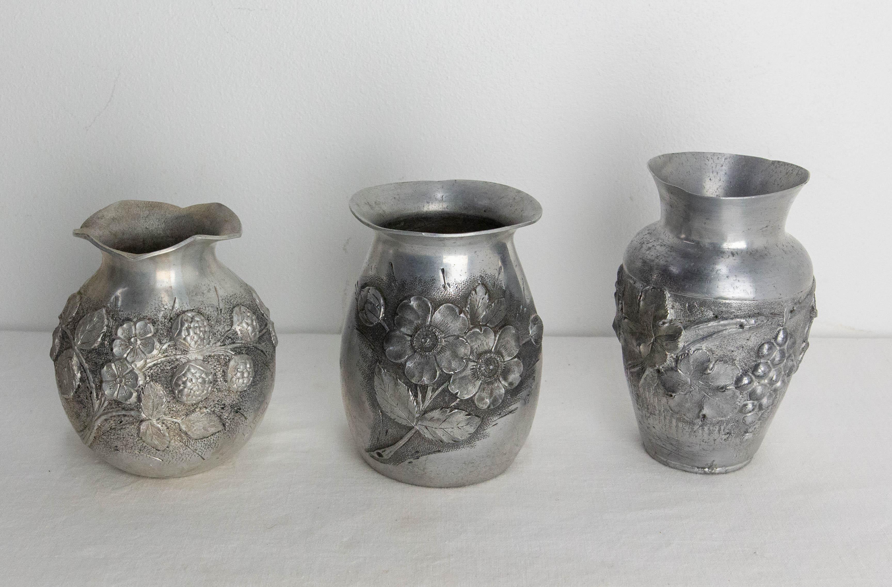 Set of three French vases with vegetal decoration: leaves, flowers and fruit (grapes and raspberries)
Embossed aluminium metal
Made in the art deco period in the art nouveau style.
Measures:
- little vase: diameter 3.54 in. height 4.53 in. (9 & 11.5
