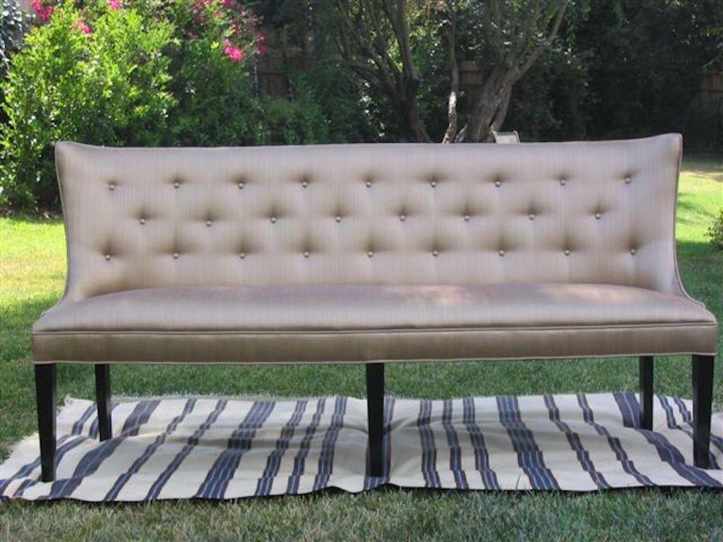 This hand-crafted upholstered settee has a concave and tufted back on a tapered leg, this is a reverence to the era of Jacques Adnet, and the 1940's . Frame in Alder wood. Each piece is stamped. Custom sizes and finishes available.