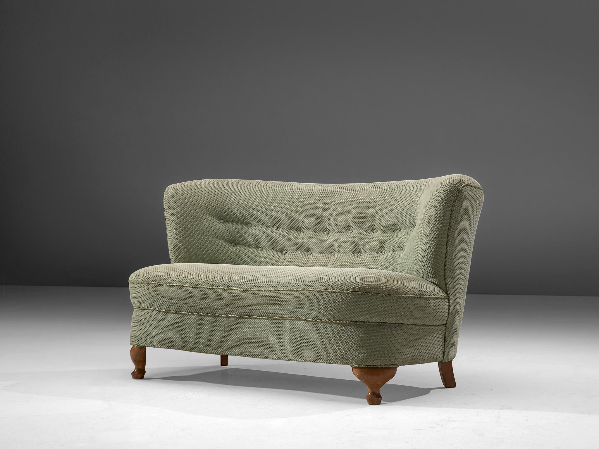 Settee, fabric, stained beech, France, 1940s

This exquisite settee of France origin adopts stylistic motifs of the Art Deco Era as can be seen in the ornate legs and the backrest which has a certain theatrical aesthetic. This design is ably