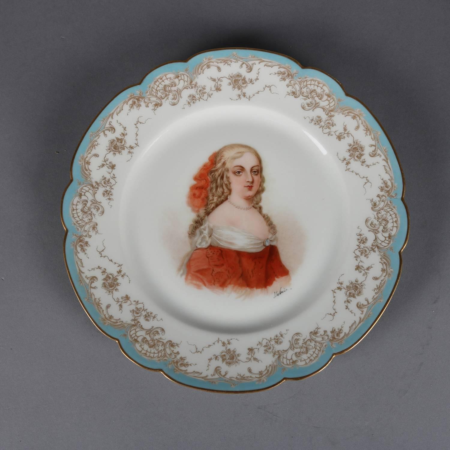 Antique French portrait plate by Sevres for Chateau de St Cloud features well with central artist signed portrait of Madame de Montespan by Debrie, rim with gilt scalloped edges and decorated with blue and gilt foliate and scroll motif, en verso